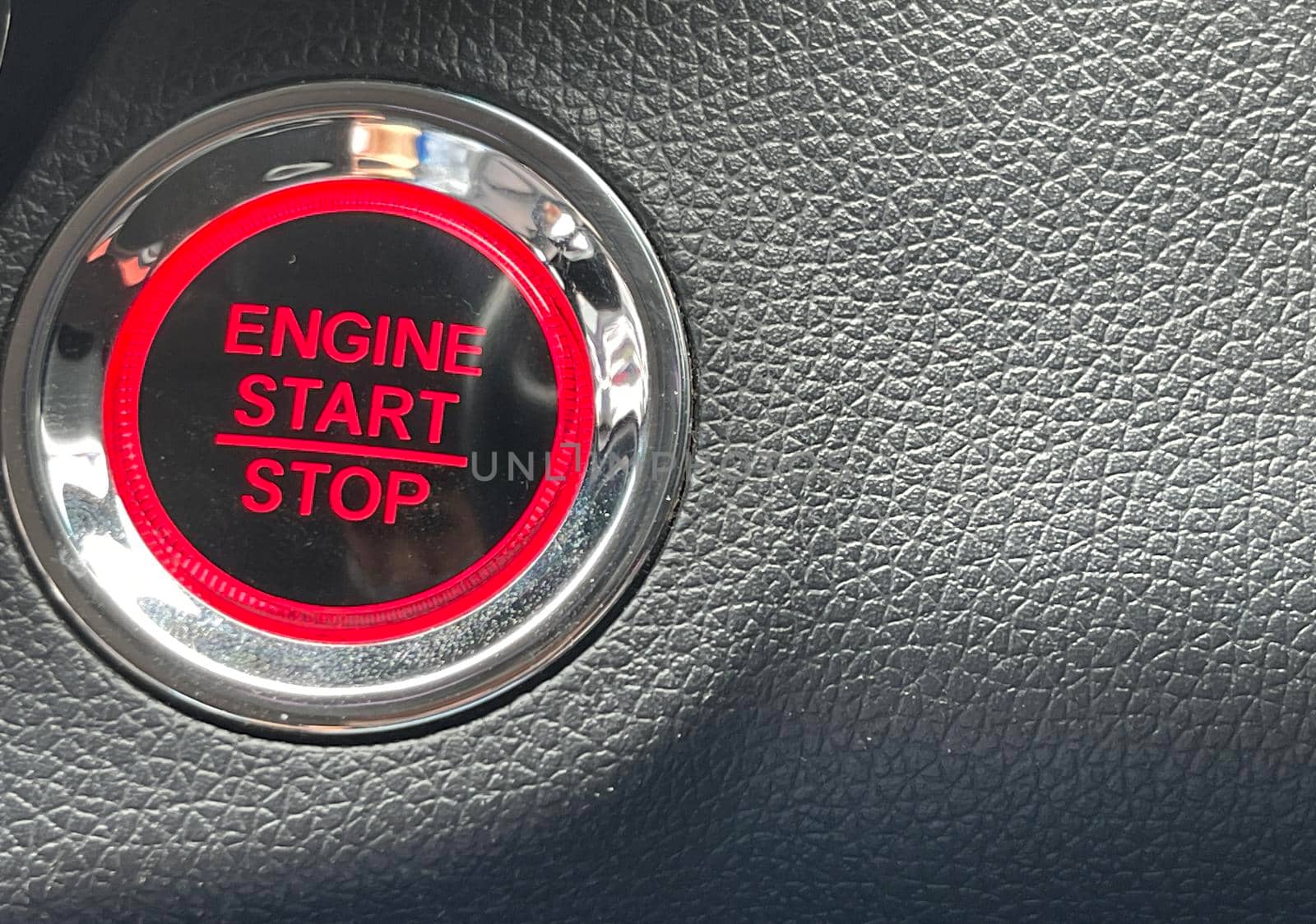 car engine start stop button on dark leather background. copy space Engine Start Button on my car