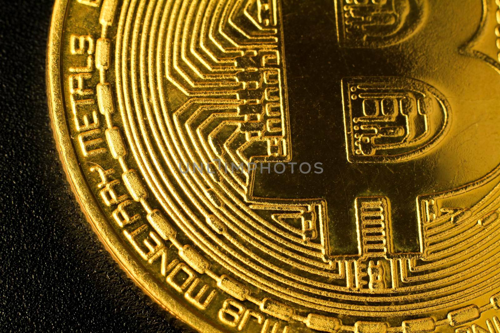 Macro closeup photography of bitcoin gold on black background.