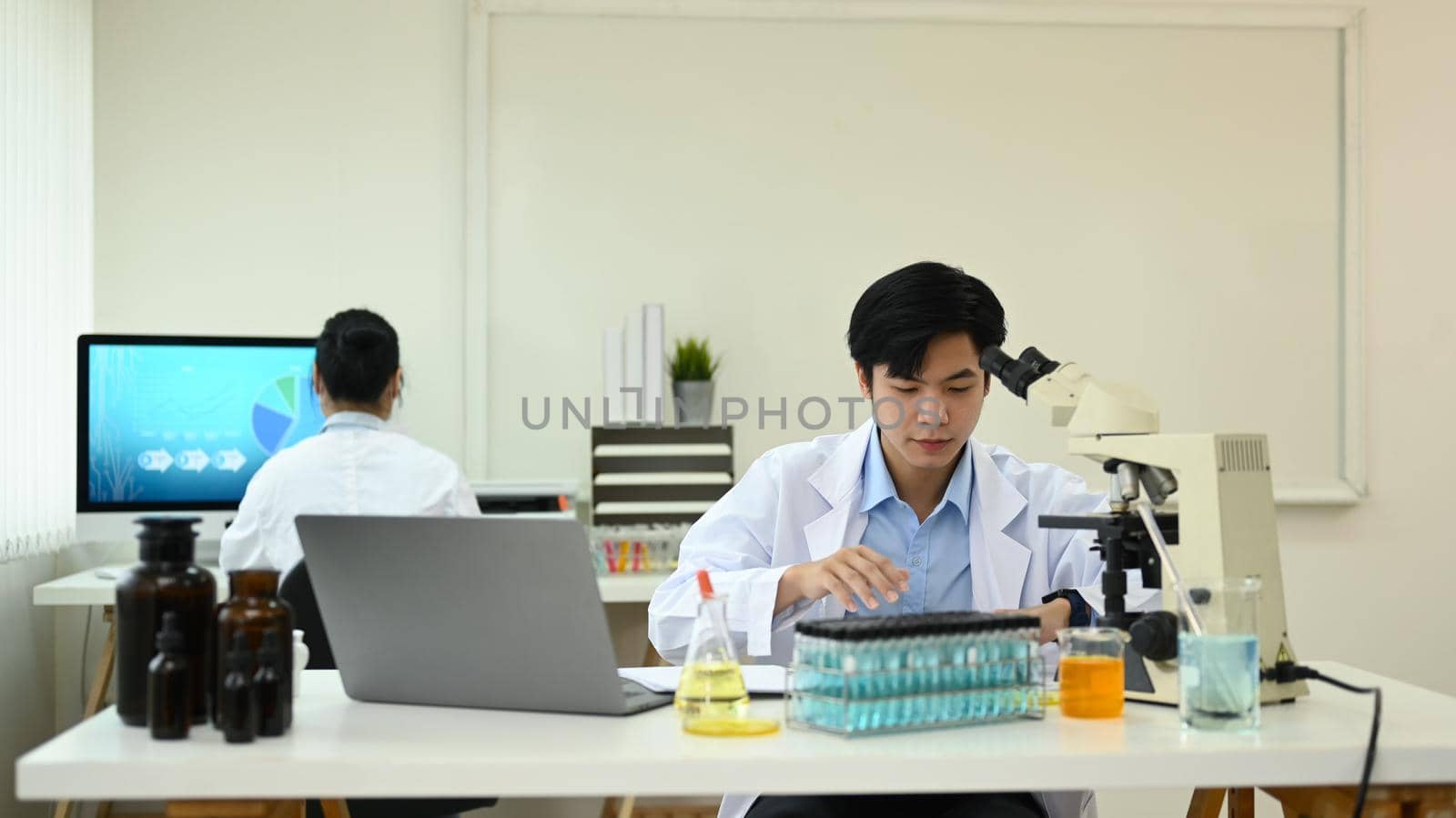 Biotechnology specialist team conducting experiment in a laboratory. Concepts of medicine and science researching.