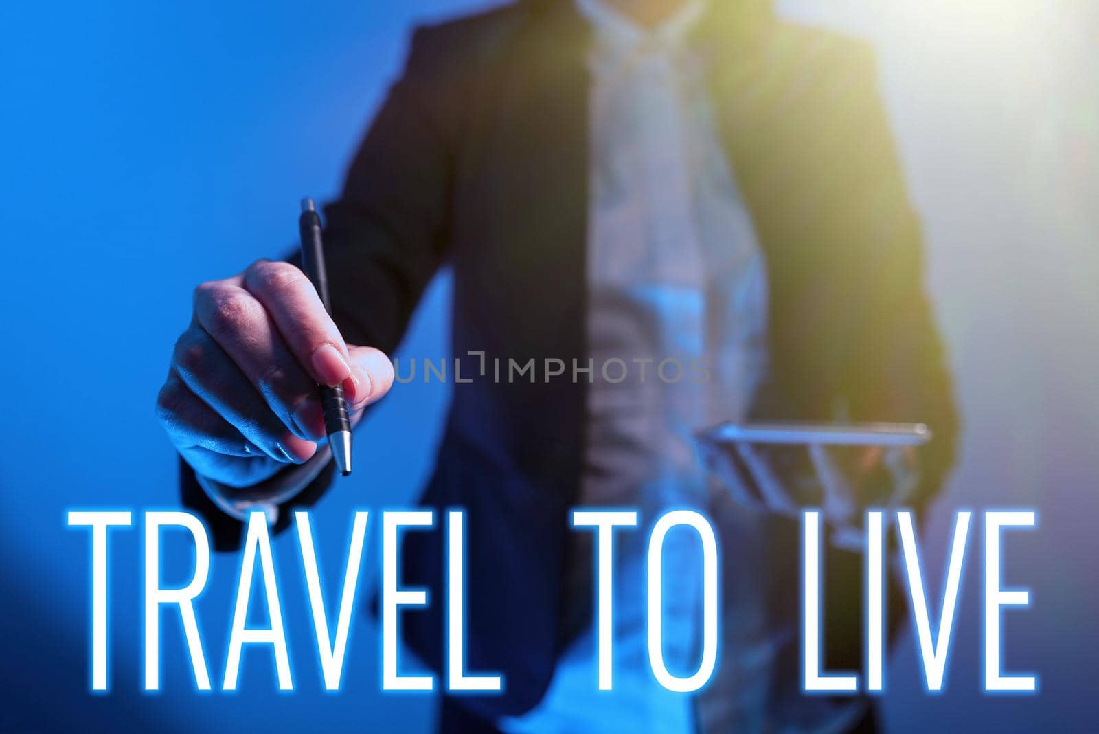 Hand writing sign Travel To Live, Word for Get knowledge and exciting adventures by going on trips Businessman With Tablet Pointing Digital S In Pattern And Information.