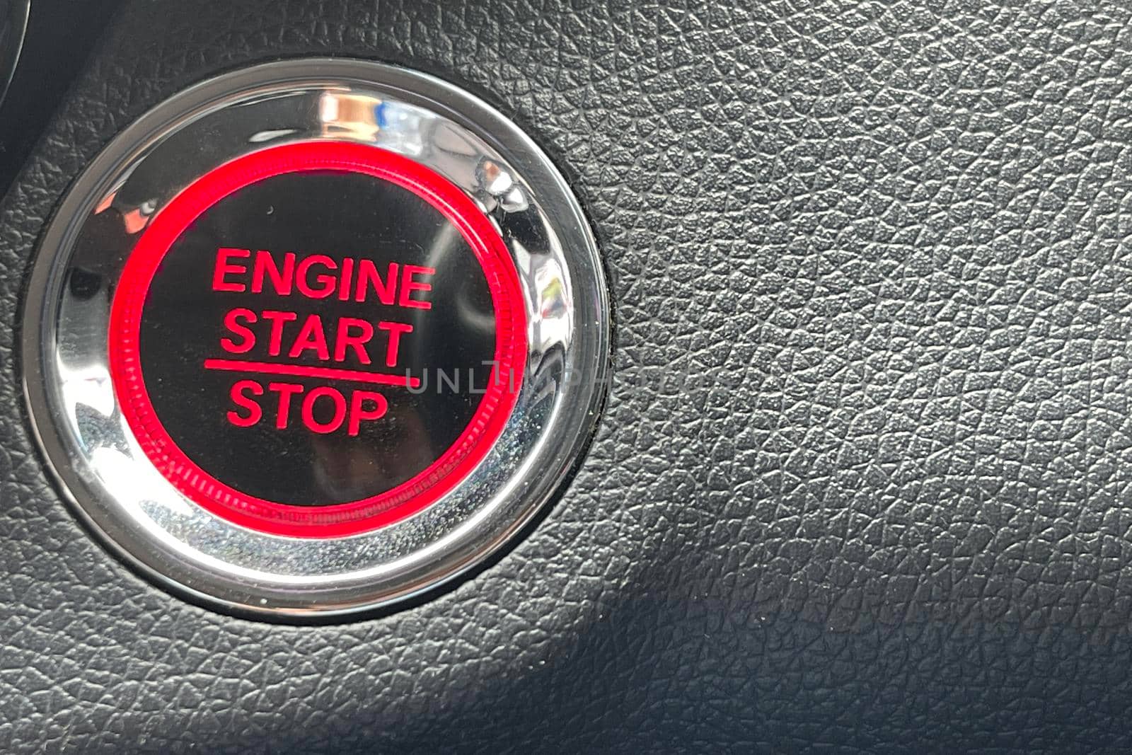 car engine start stop button on dark leather background. copy space Engine Start Button on my car