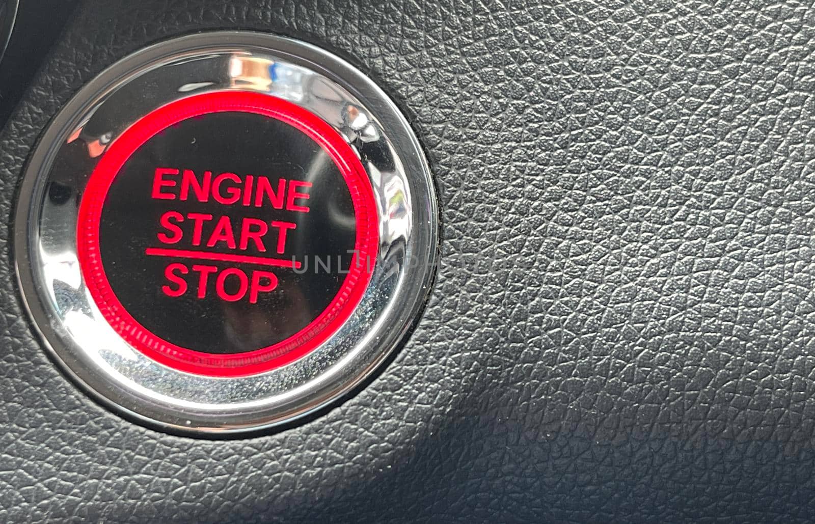 car engine start stop button on dark leather background. copy space Engine Start Button on my car