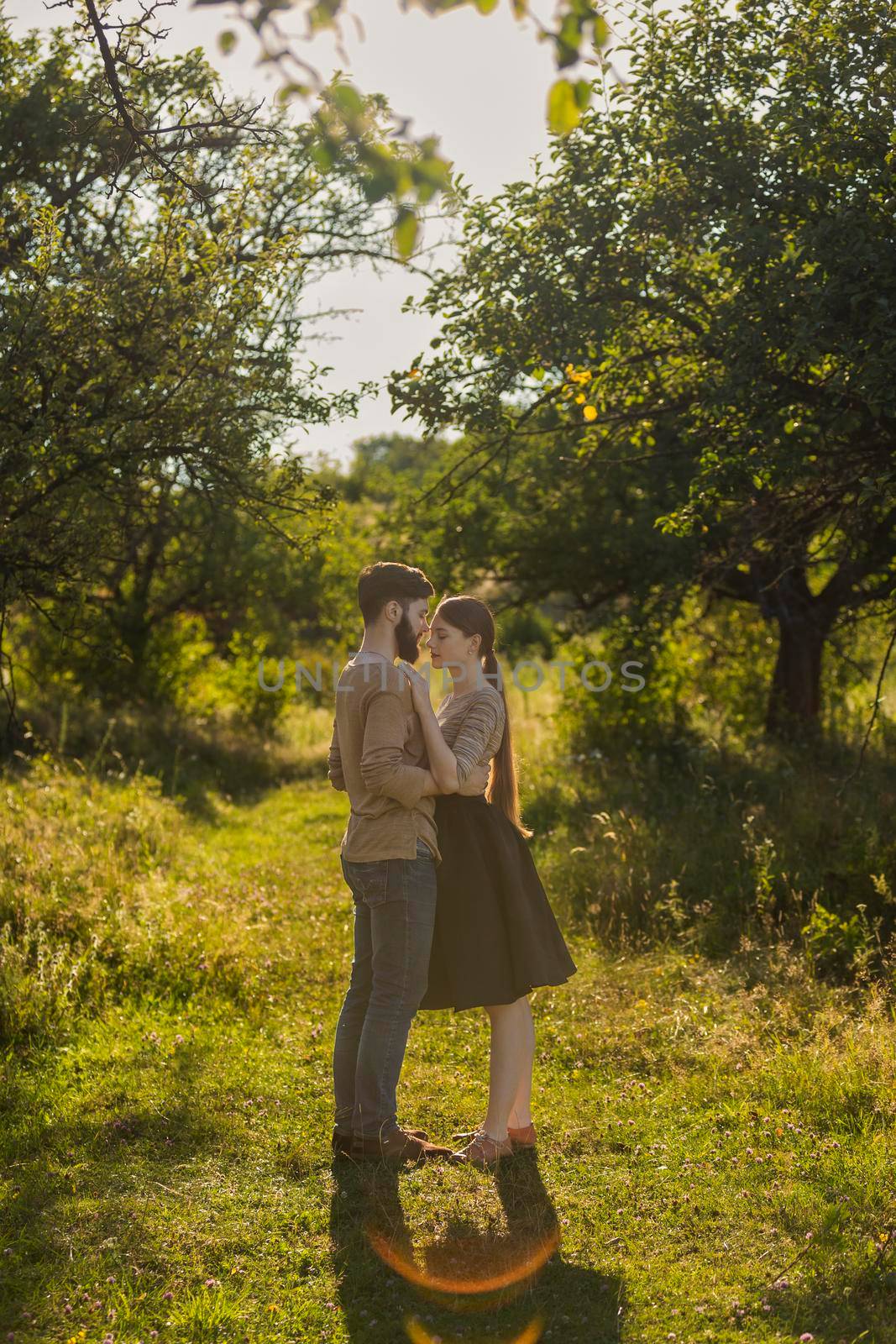 young couple hugging on nature background