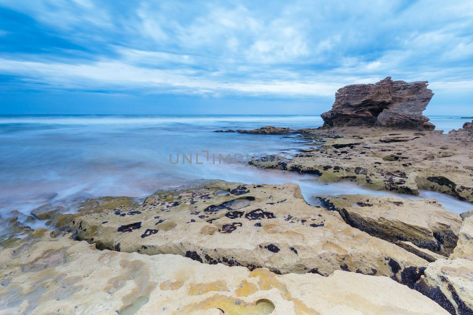 Boag Rocks at Gunnamatta Ocean Beach on a stormy afternoon in St Andrews Beach in Victoria, Australia