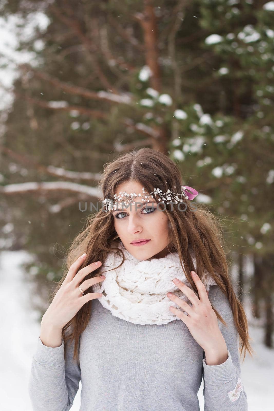 Beautiful bride in a white dress with a bouquet in a snow-covered winter forest. Portrait of the bride in nature by Annu1tochka