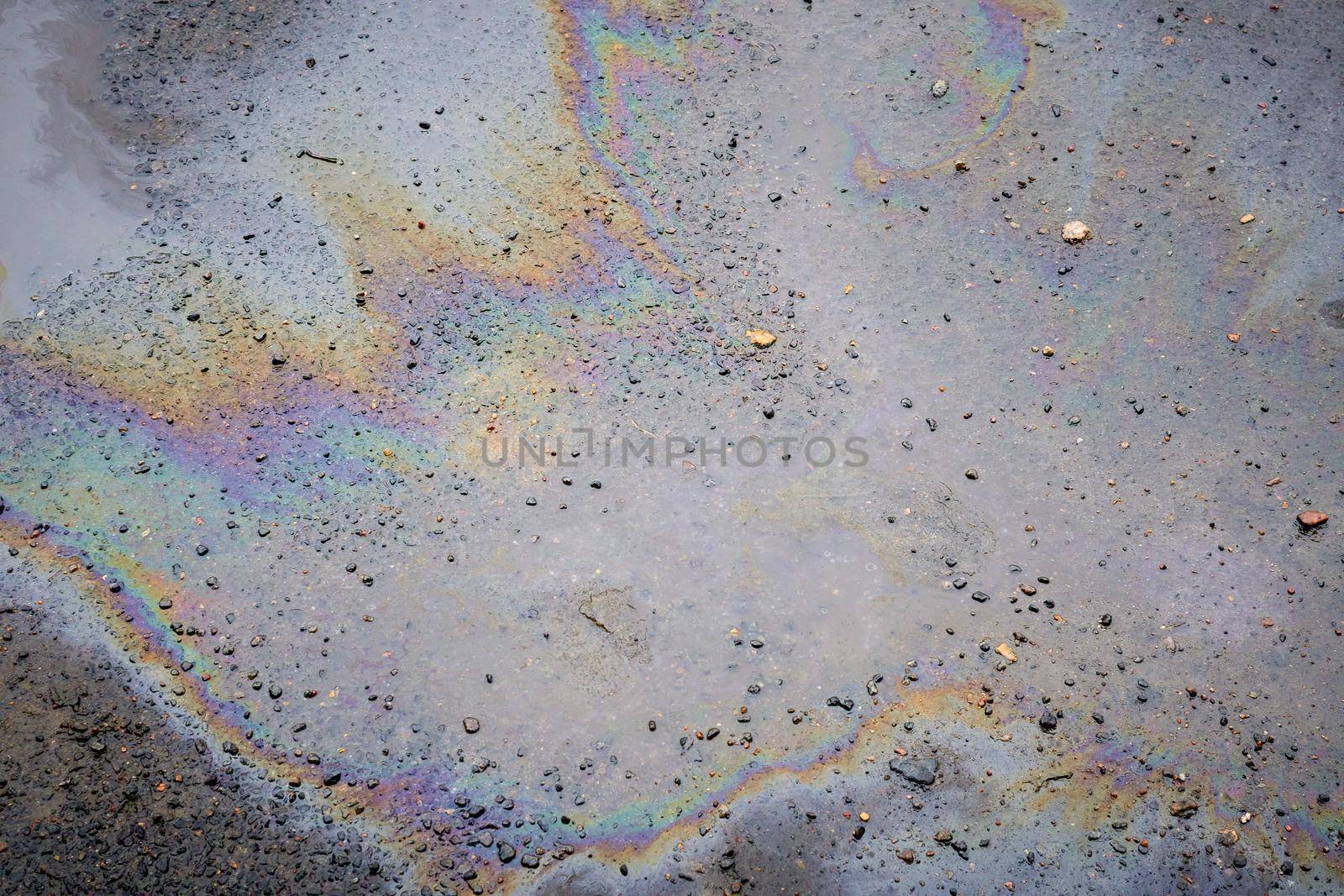 Oil slick on the asphalt road background
