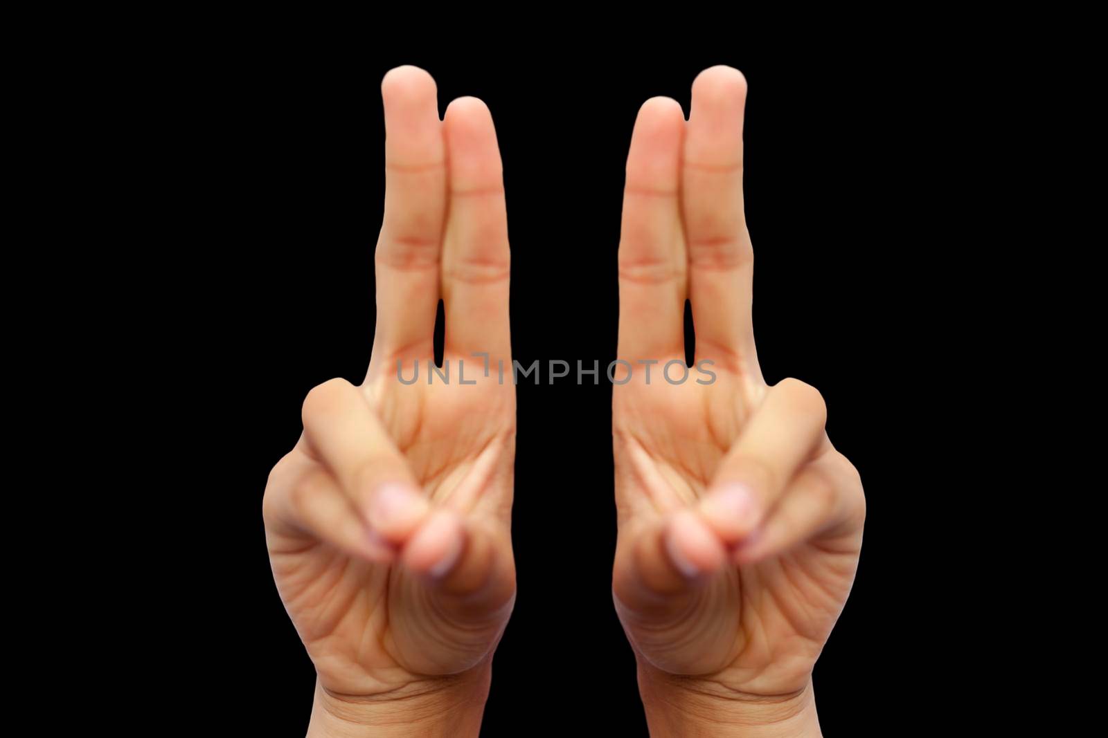 Isolated pair of male hands demonstrating Kapitthaka Mudra isolated on a black colored background. Vertical shot of Kapitthaka Yoga Mudra.