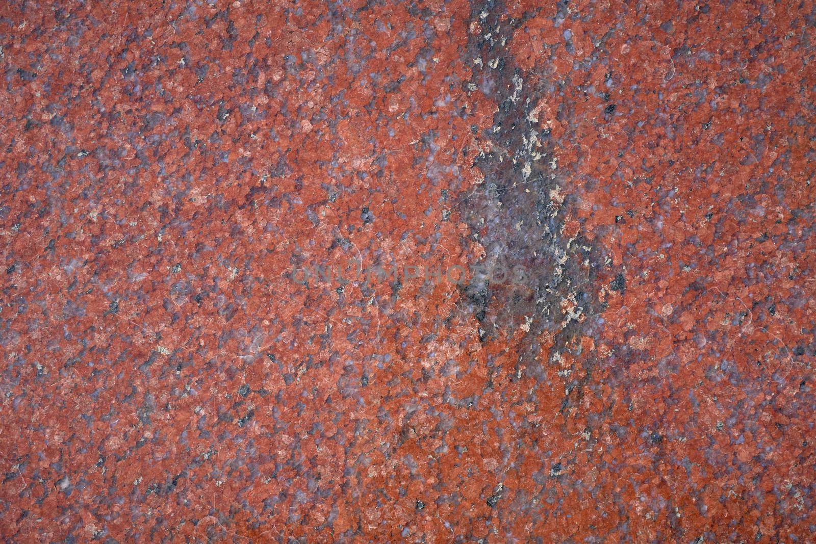 Background texture of polished red granite, close-up.. Abstract granite background for design