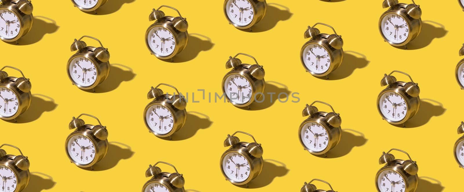Pattern of an alarm clock on a colored background. Monochrome time concept. Banner format