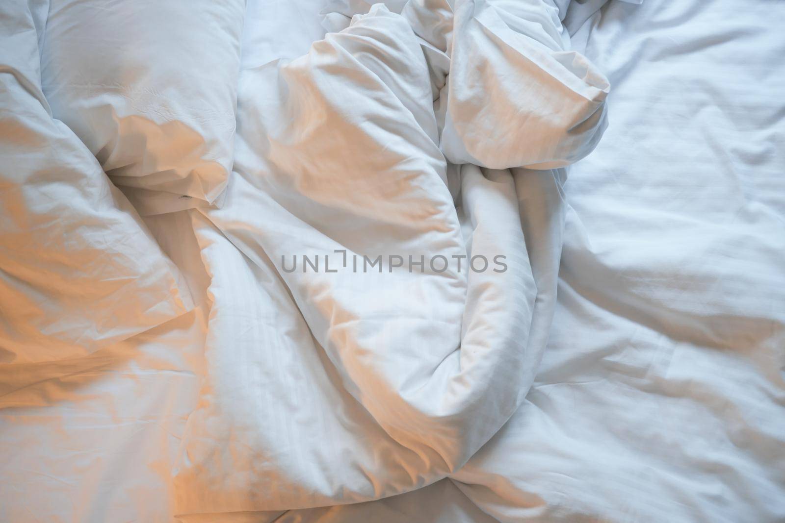messy bed in early morning , messy bed after waking up .