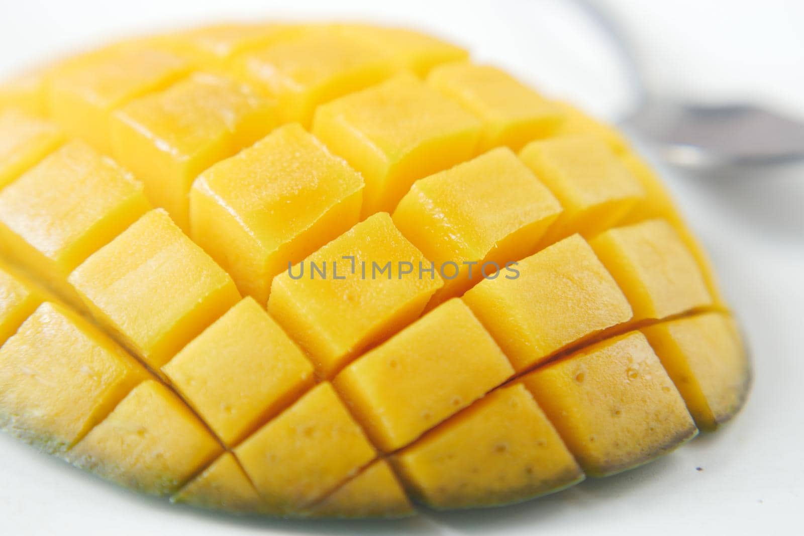 yellow ripe cut mango in a bowl top down.