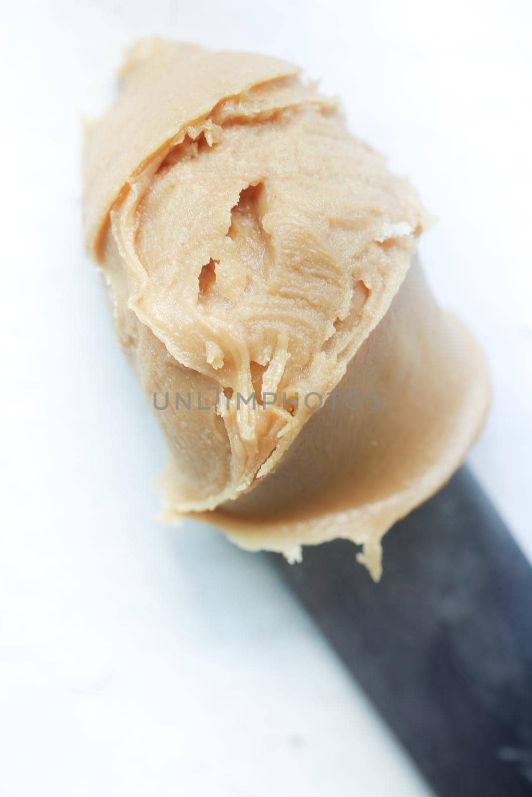close up of peanut butter on knife .