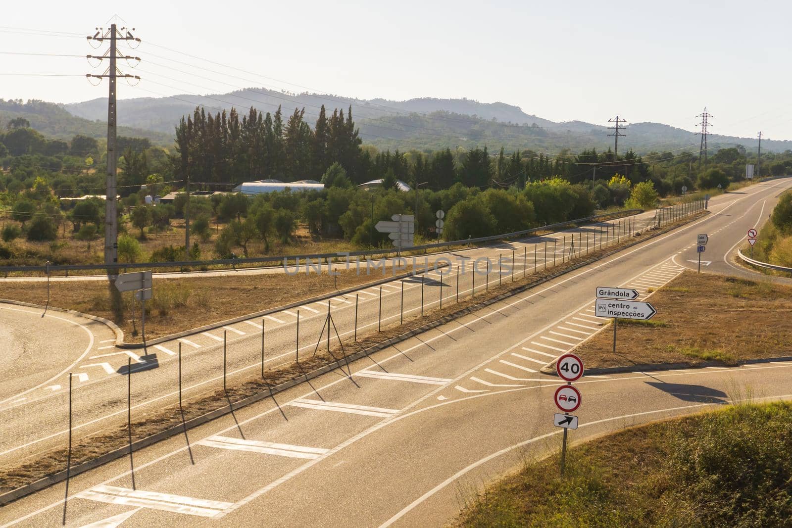 Turn of the road leading to the portuguese city of Grandola, with traffic signs