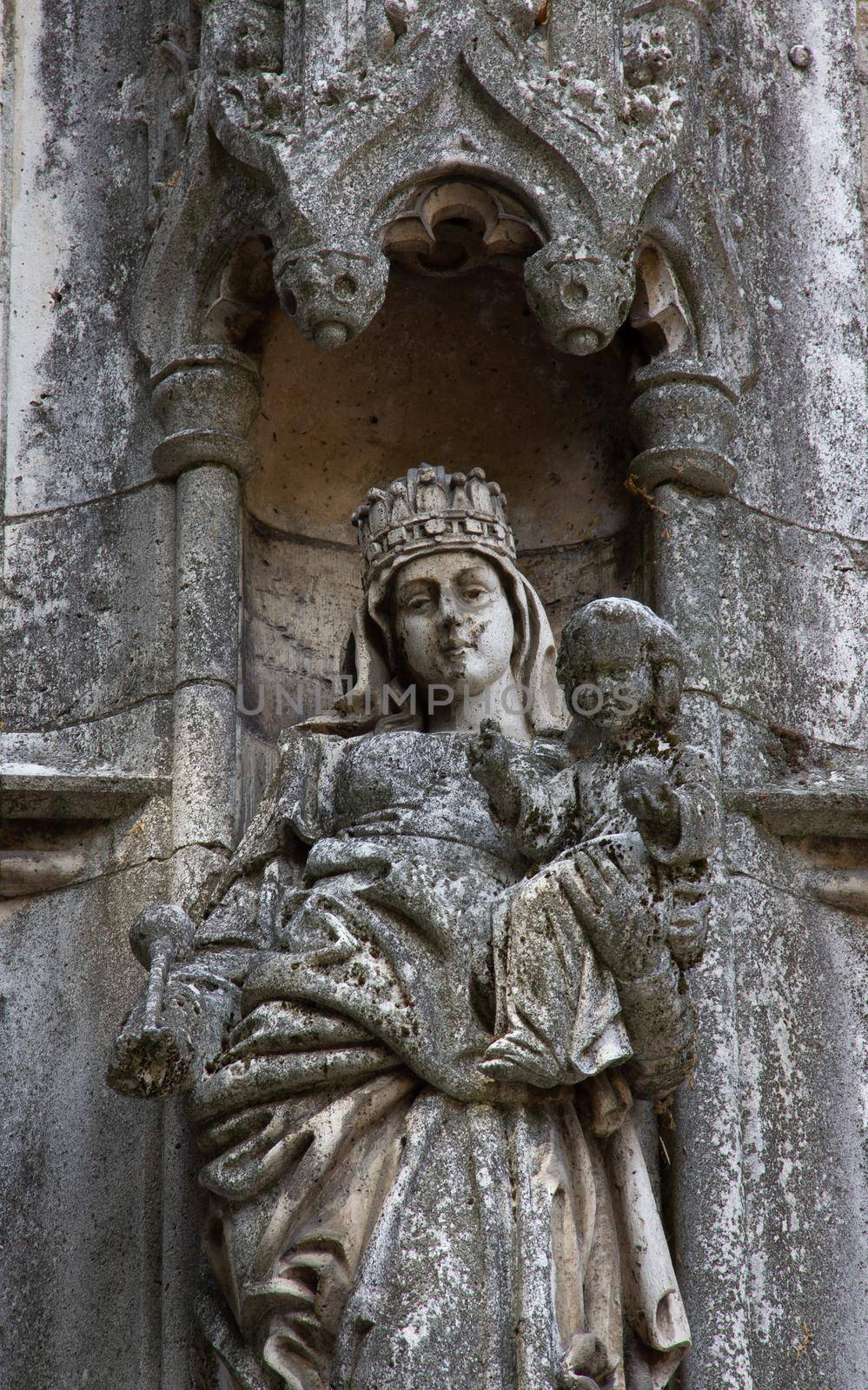 Eroded church building statue with Mary's child. by gallofoto