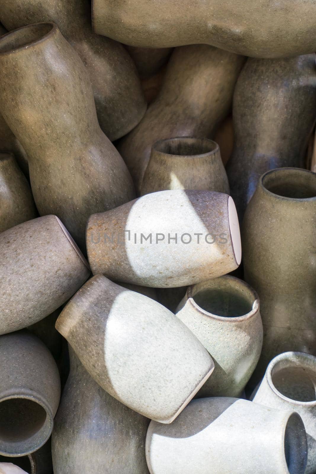 Ceramic grey-green handmade vases background close up