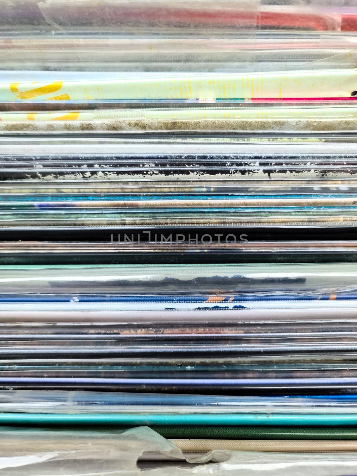 Numerous vintage signs and vinyl records in a box seen from above