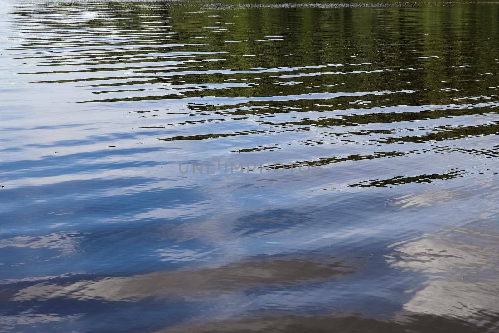 Water surfaces with waves and ripples and the sunlight reflecting at the surface
