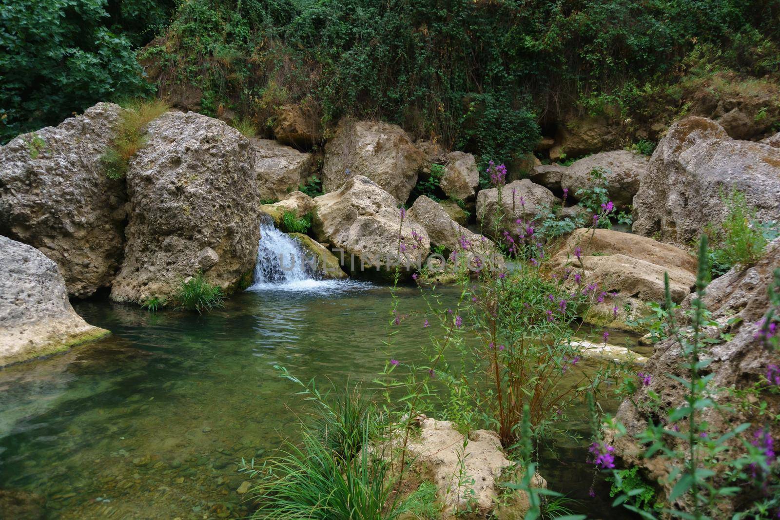 swimming pools with a small waterfall in a mountain river with cold and crystalline waters.