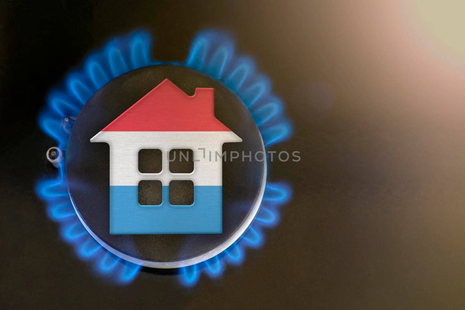 gas crisis. Rising utility costs in Luxembourg. Energy crisis, export-import problems in Luxembourg. The concept, gas burner and house model are colored in the colors of the flag