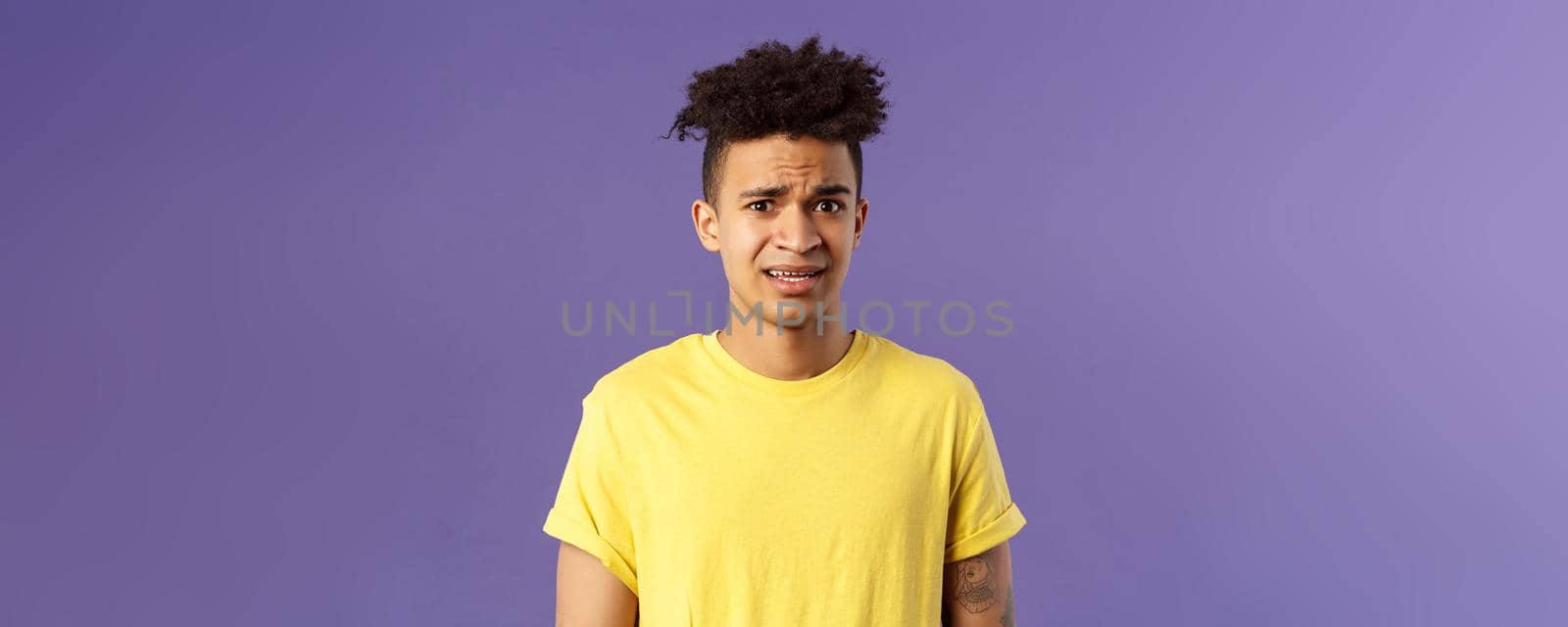Close-up portrait of awkward and embarrassed young hispanic guy looking nervous, meeting girlfriend parents, stare scared and with panic, feeling concerned, cringe over purple background by Benzoix