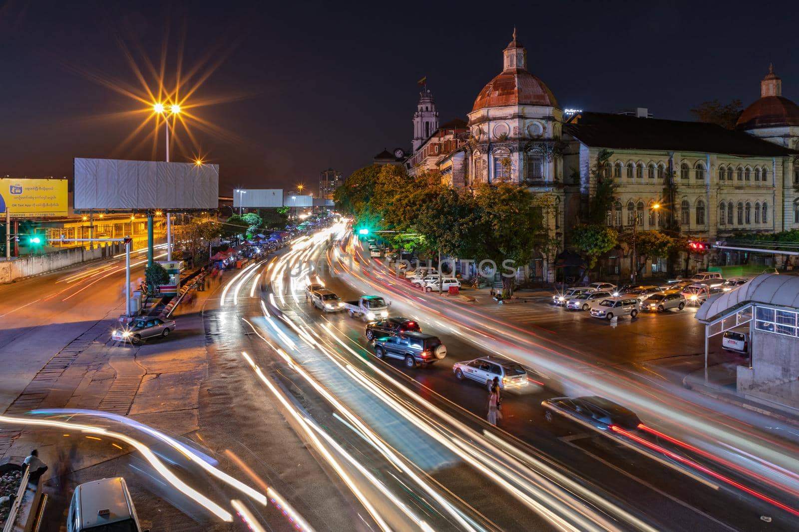 A long exposure night shot of a Yangon main street with beautiful buildings in Myanmar