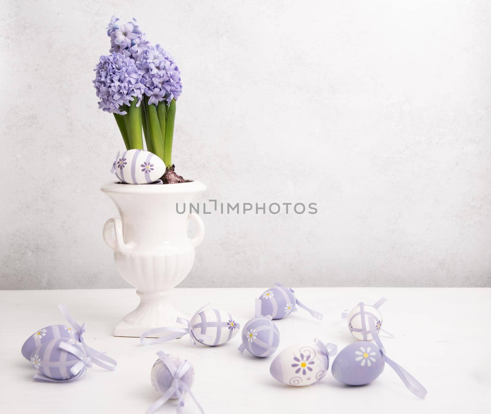 Easter eggs and Lilac hyacinth in a vase, spring still life, copy space. High quality photo