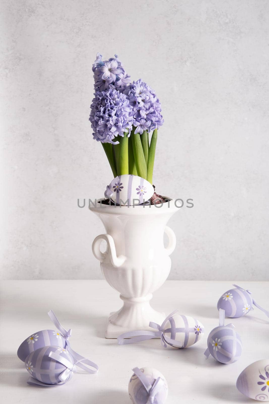 Easter eggs and Lilac hyacinth in a vase, spring still life, copy space. High quality photo