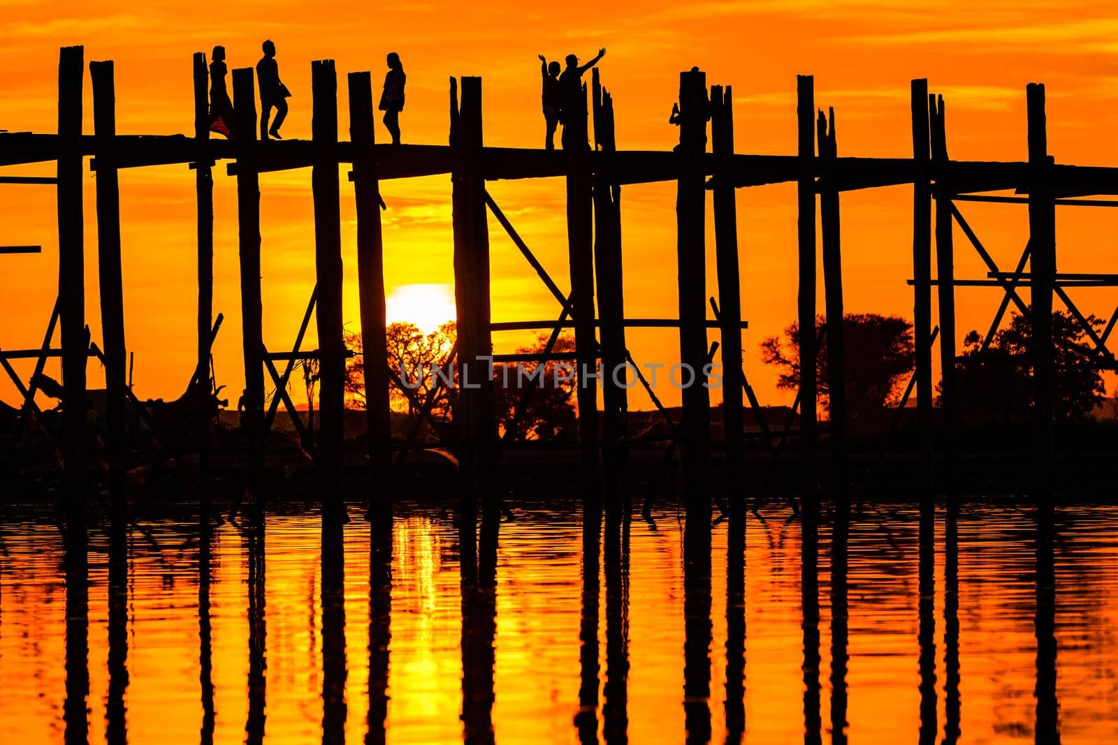 Sunset behind the longest teak bridge in the world in Myanmar