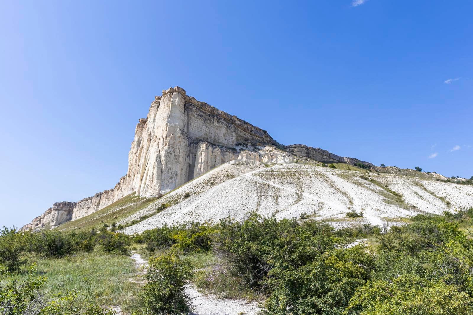 white chalk limestone rock against a blue sky aerial view by roman112007