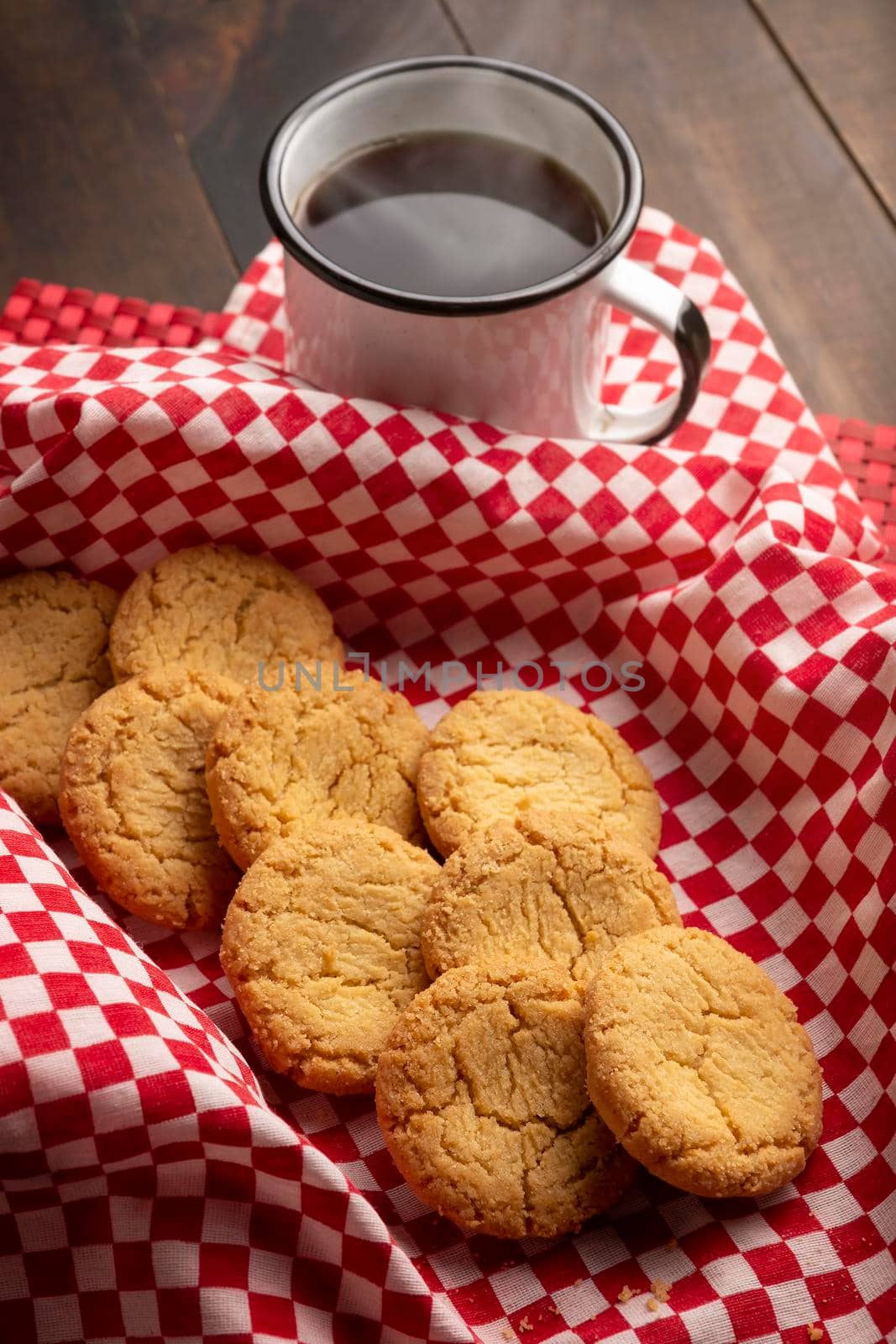 Homemade crunchy cookies and a coffee cup on wooden rustic table