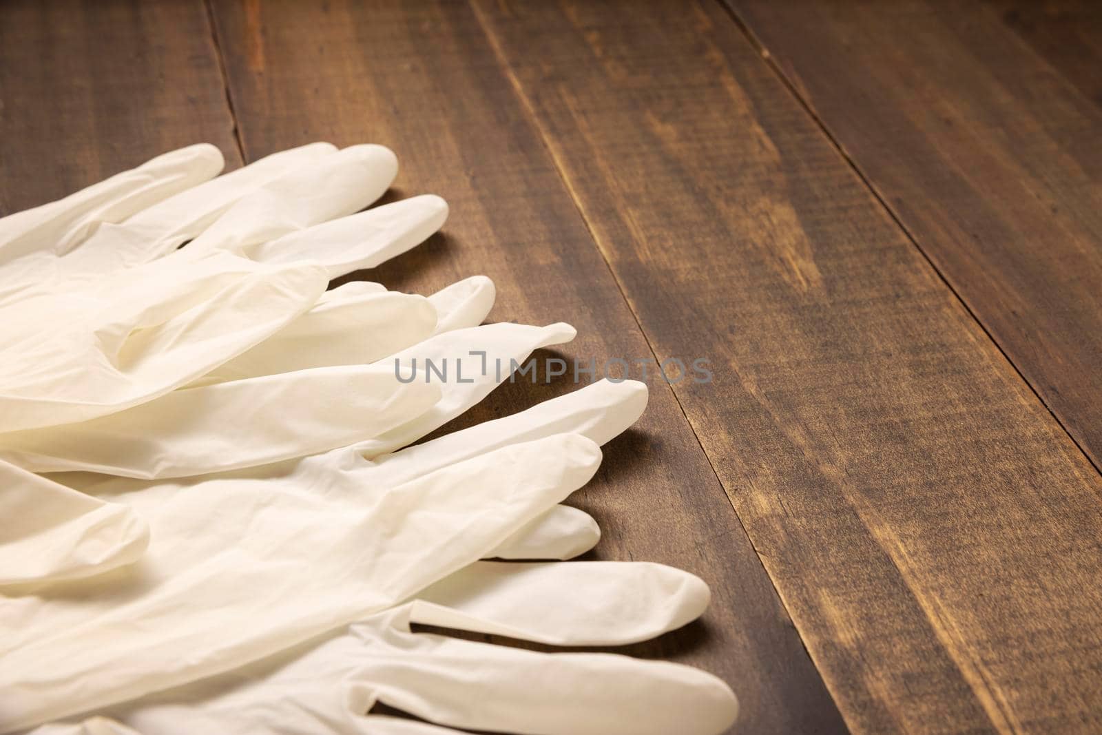 medical latex gloves for protection on wooden background. Useful for pandemic prevention concept