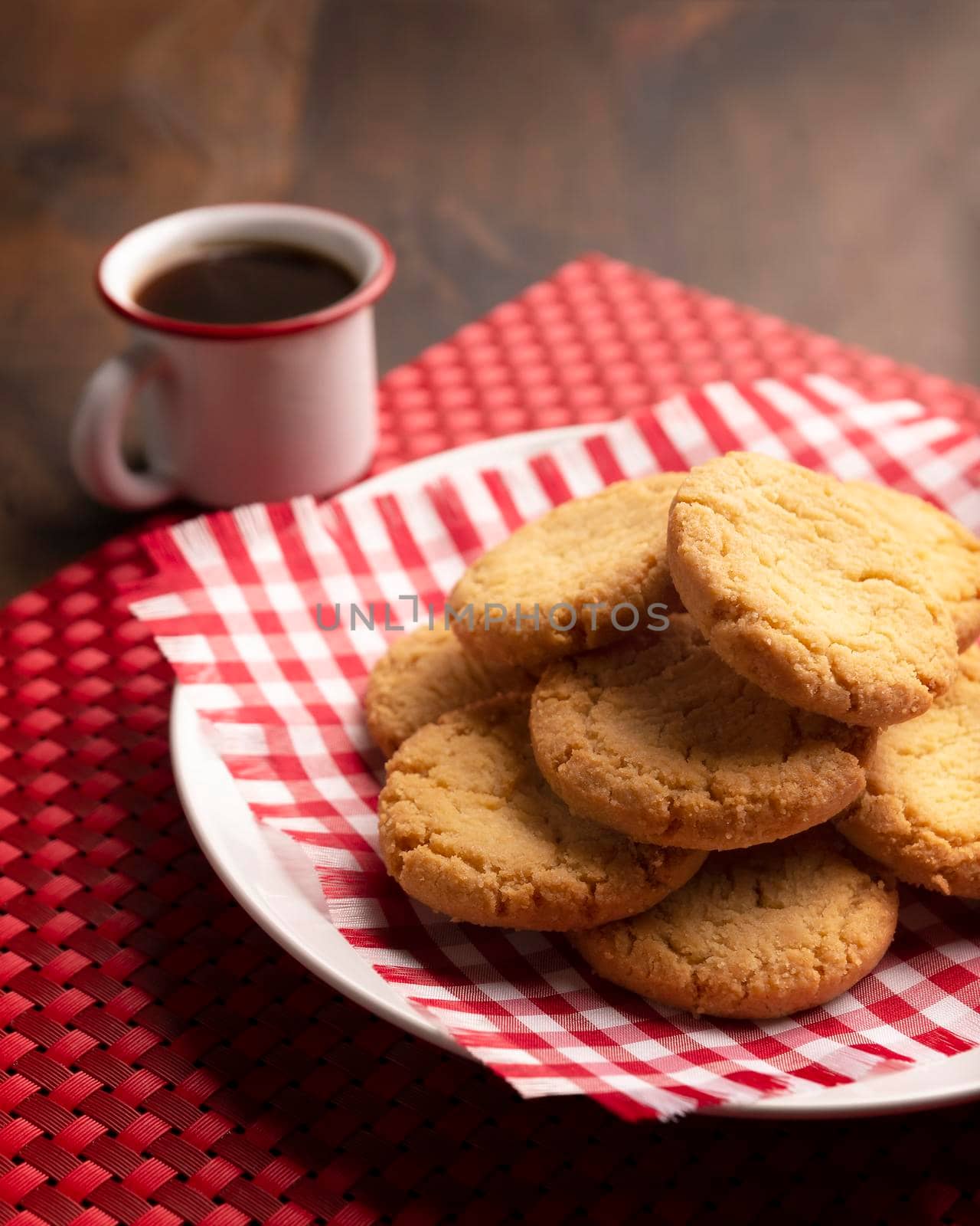 Homemade crunchy cookies and a espresso coffee cup on wooden table