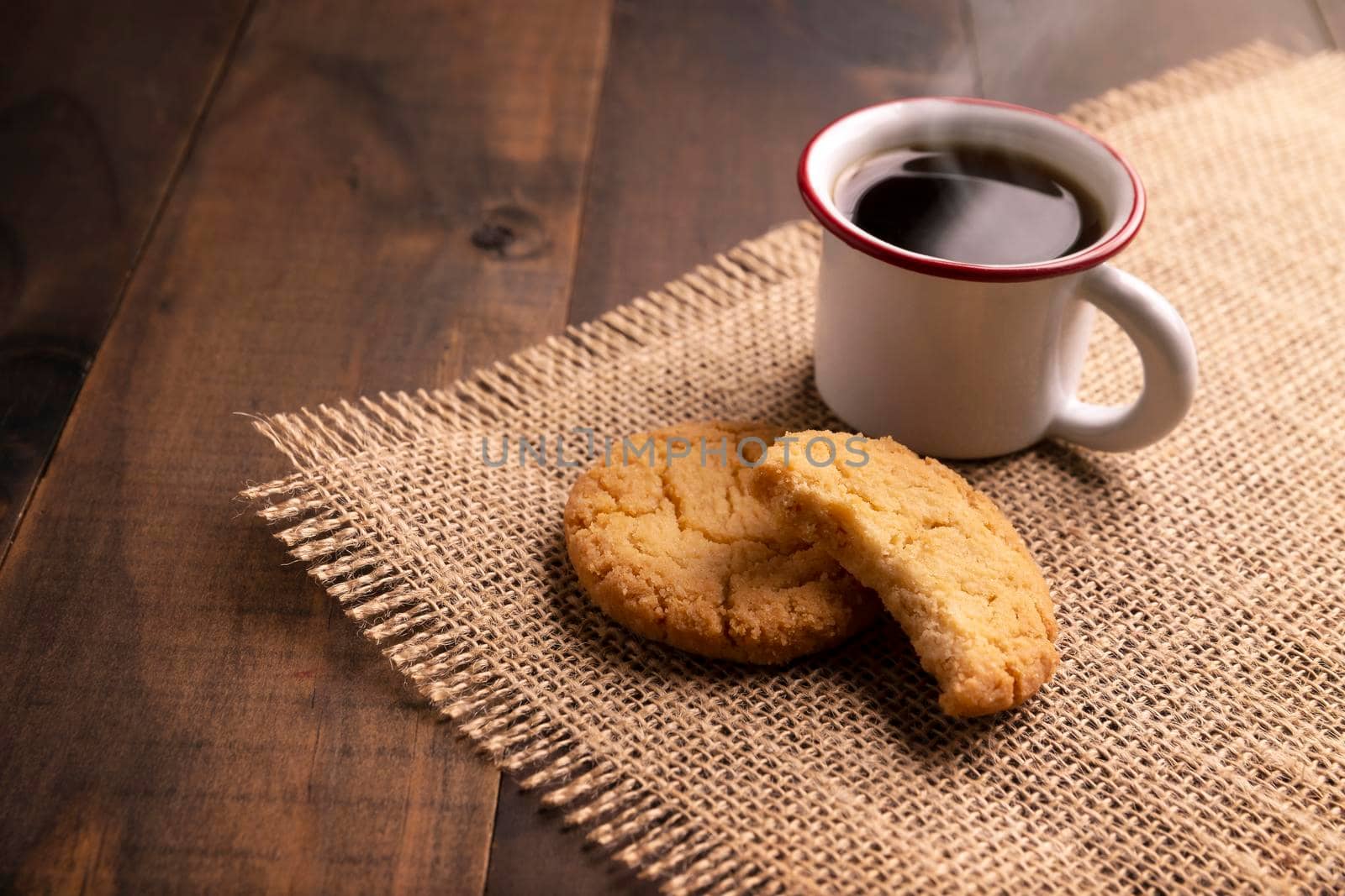 Close up of Homemade crunchy cookies and a espresso coffee cup on wooden rustic table