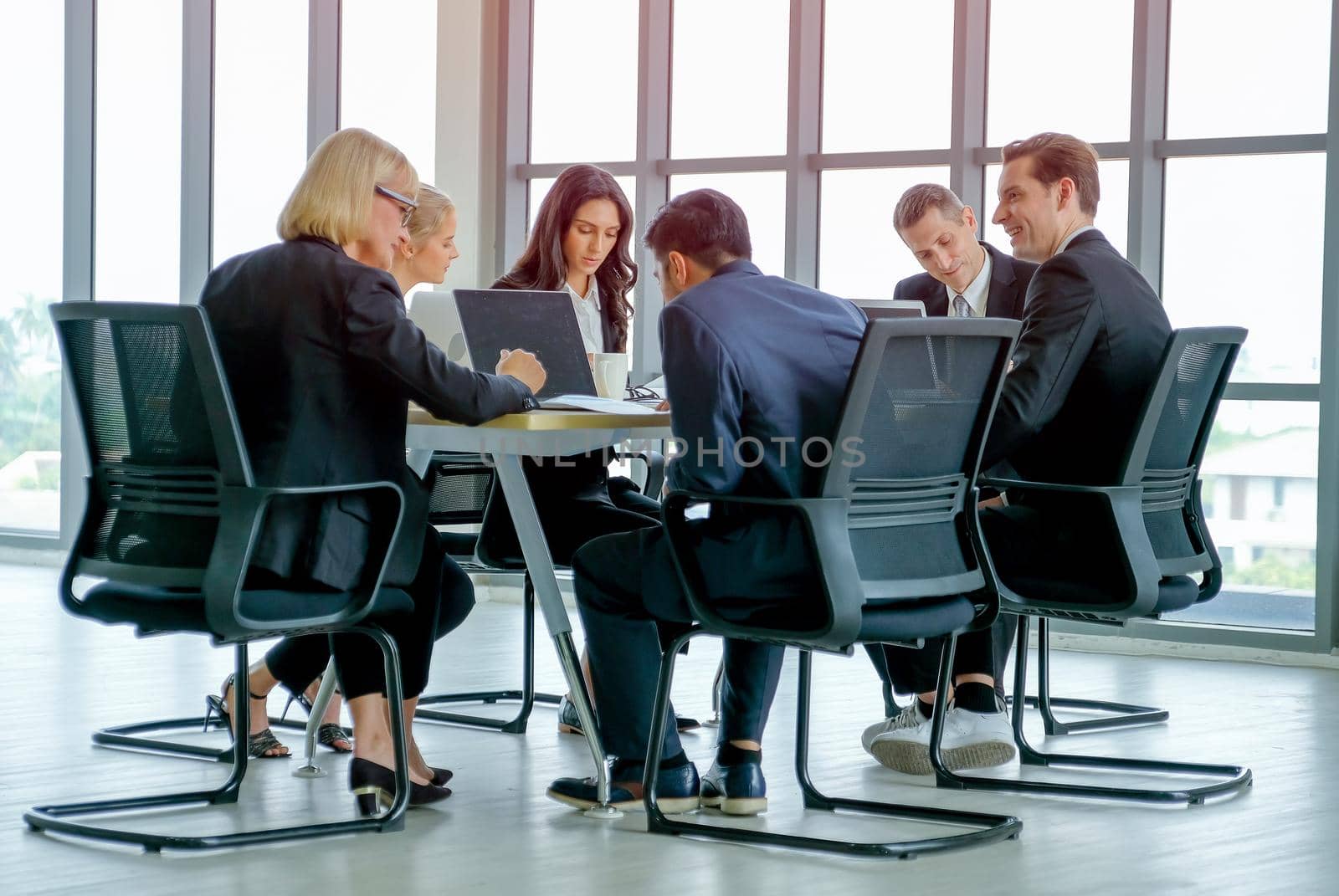 Business man discuss with his team about the project with their meeting and they look happy.