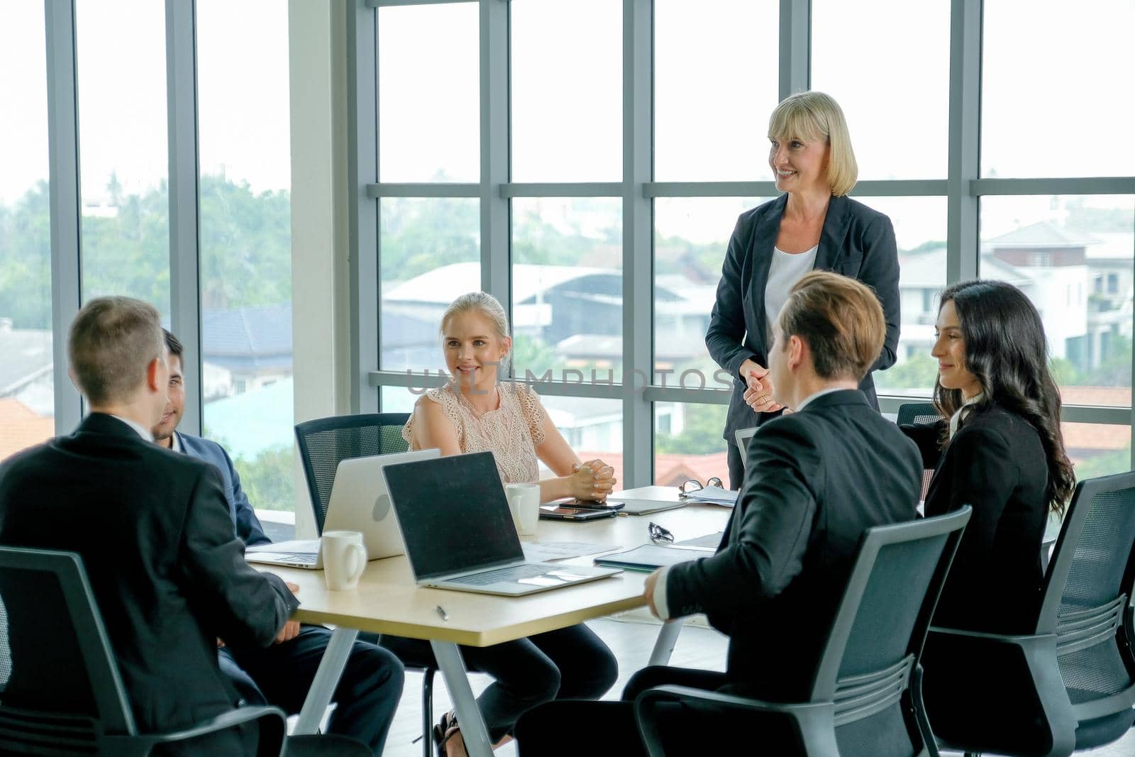 Group of business men and women in the conference or meeting to discuss about their company working.