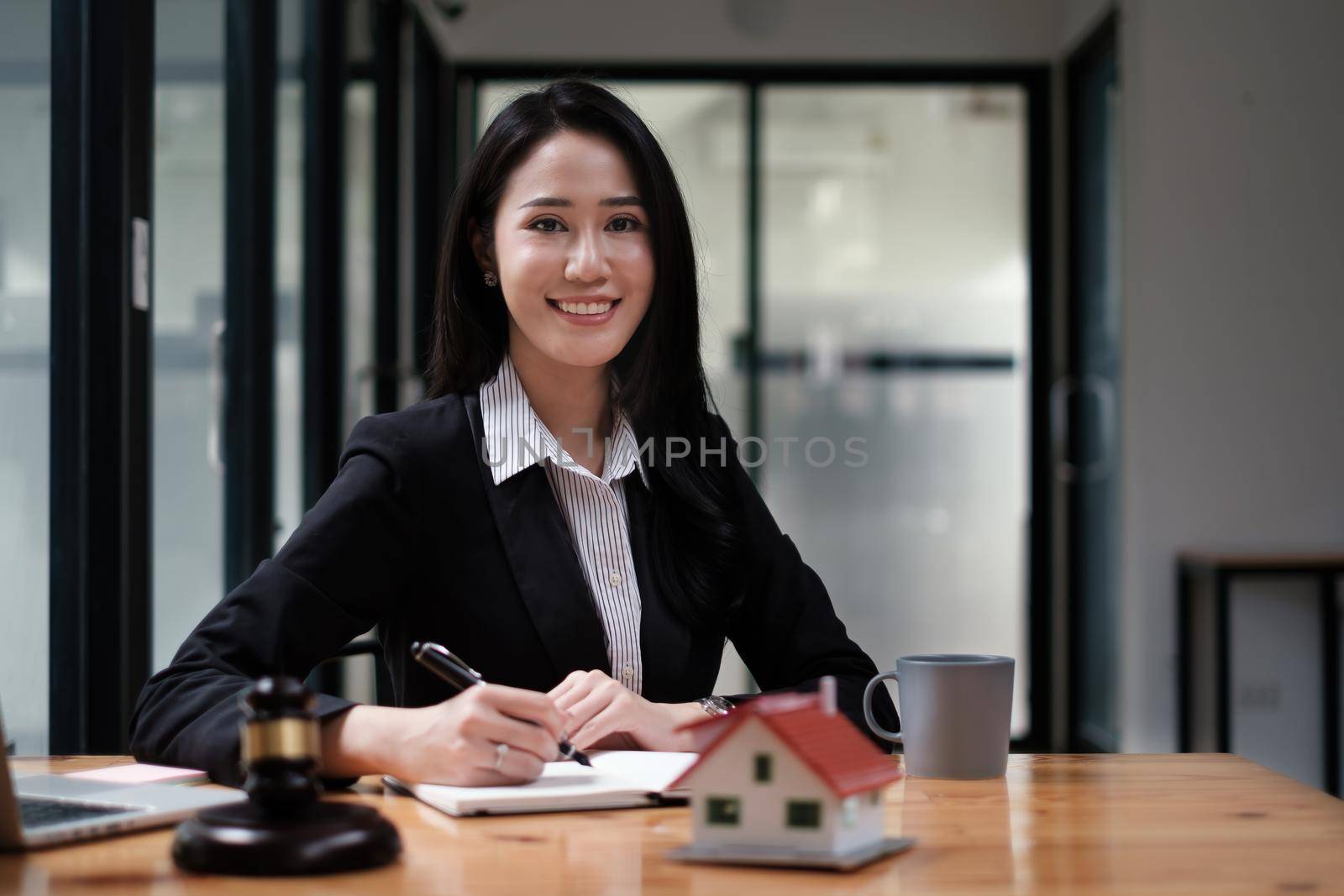 Business woman or legal advisor sitting wooden desk in office. Law, legal services, advice,Judge auction and real estate concept