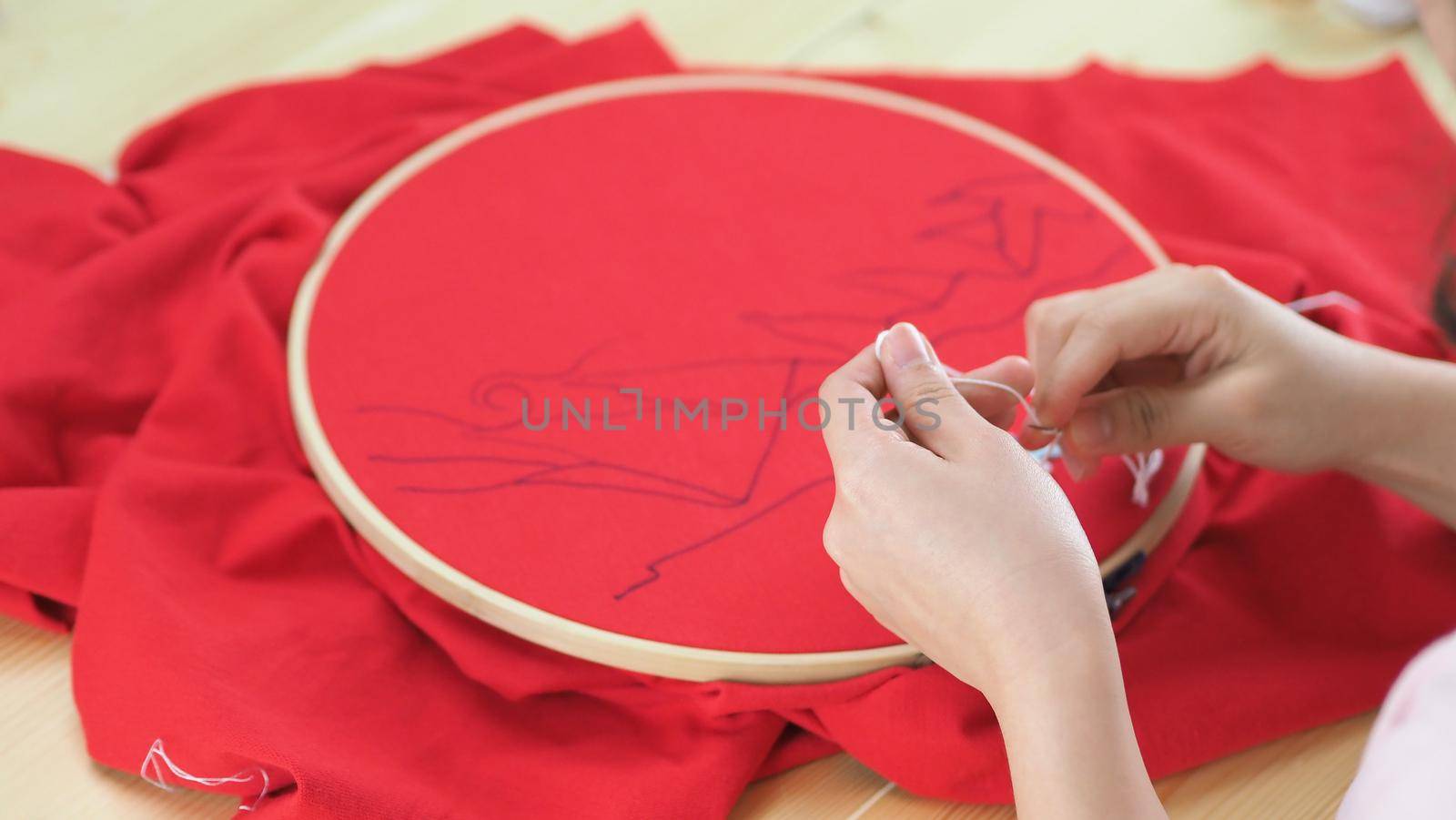 Woman hands and craft work. Embroider sewing by hand.  by gnepphoto