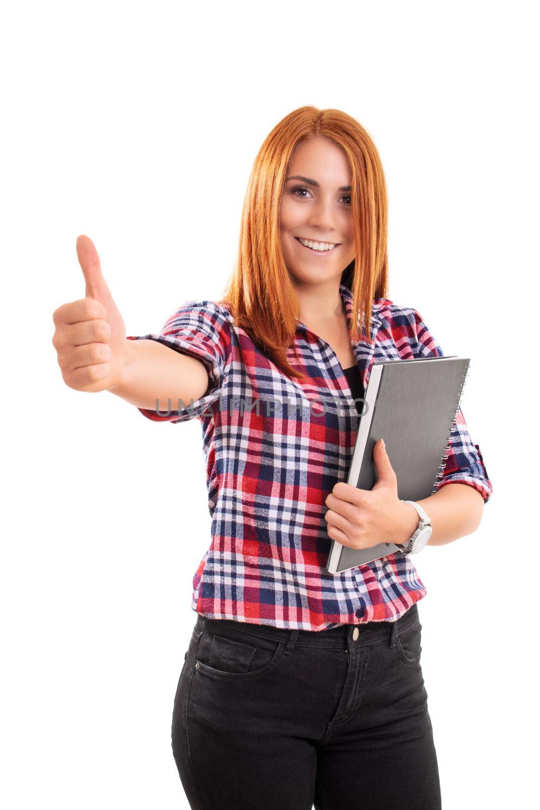 Beautiful smiling young woman holding a notebook and giving thumb up, isolated on white background. Successful student girl showing a positive gesture. Winner, approval, success concept.