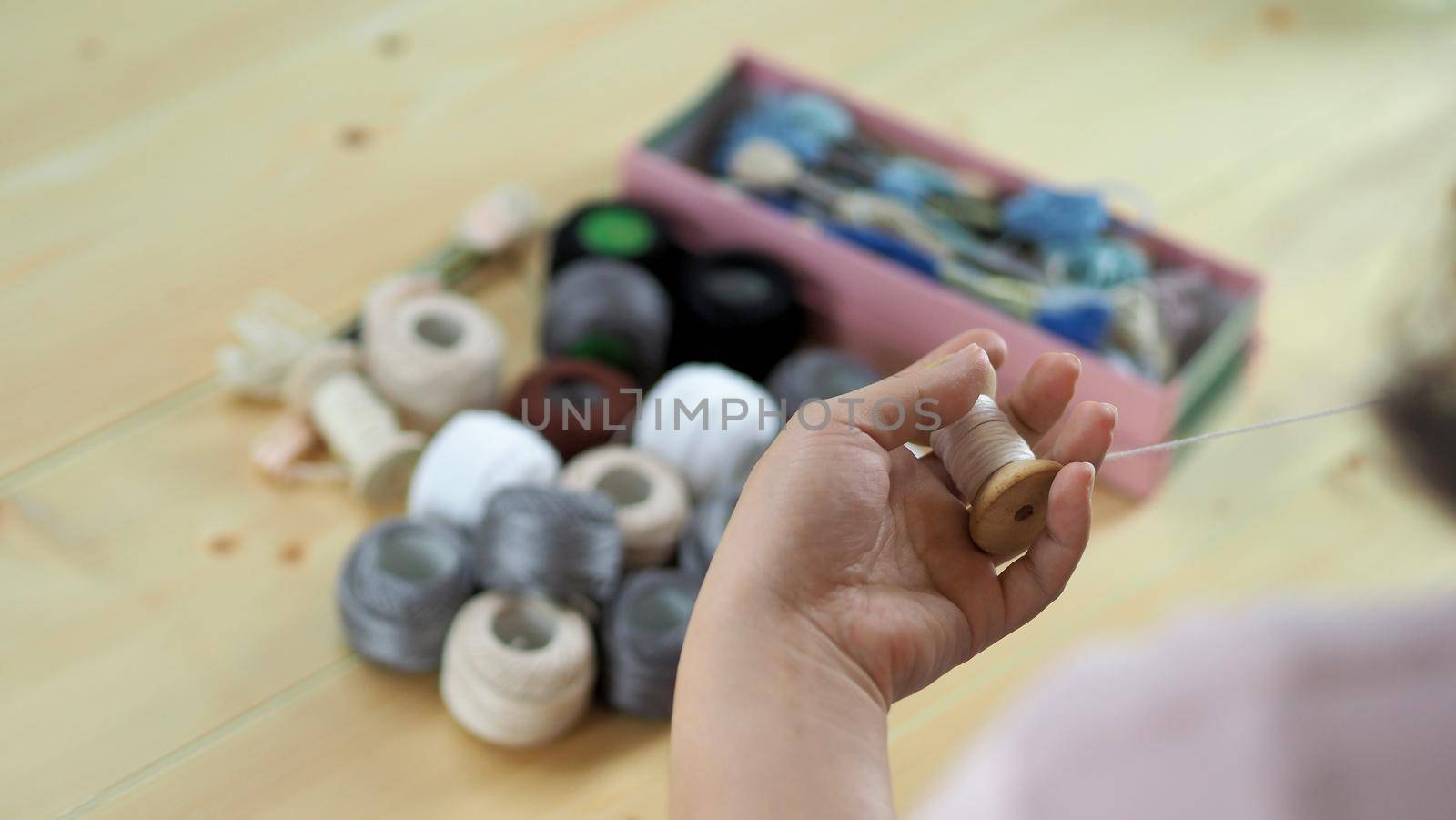 Woman hands and craft work. Embroider sewing by hand.  by gnepphoto