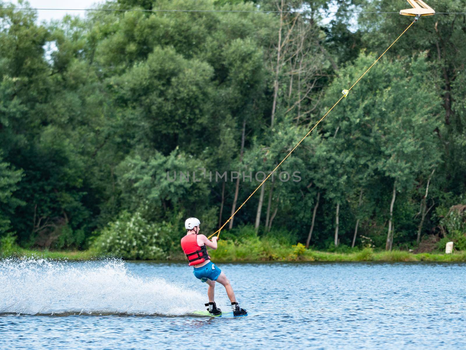 Straz, Czechia. 29th of July, 2021. Man wake boarding on lake in high speed.