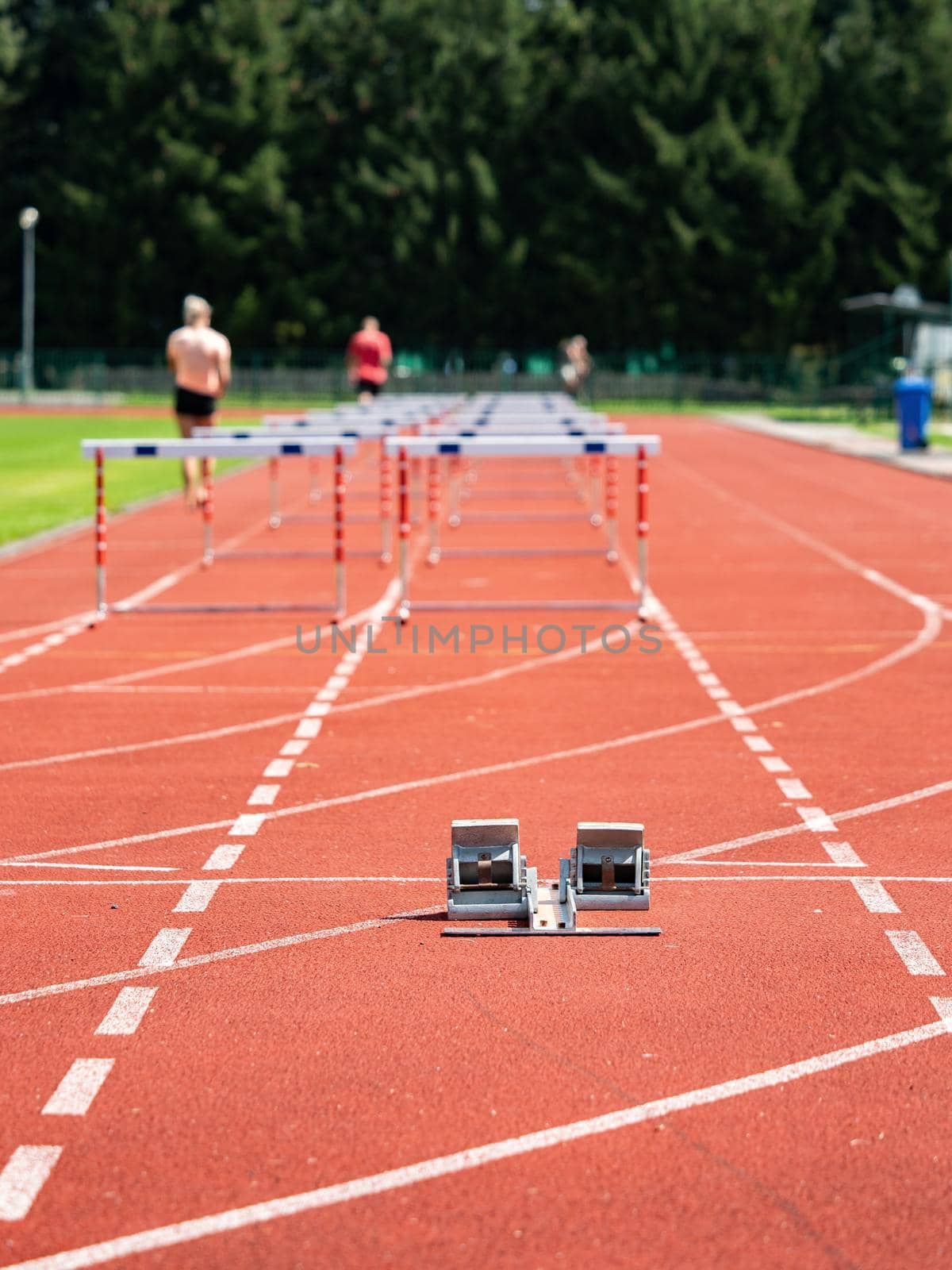 Obstacle course training. Athletics Starting Blocks and red running tracks in a stadion