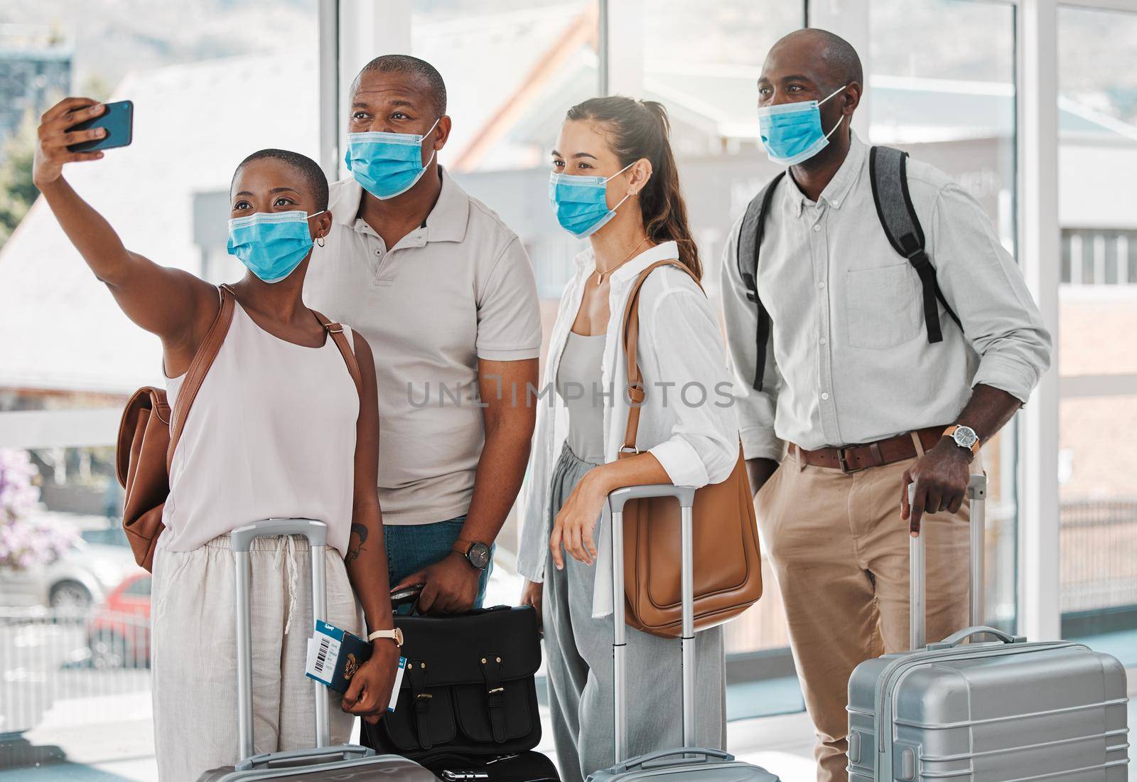 Travel people taking selfie with covid face mask at the airport on their trip, travel or holiday overseas. Group of people or friends with suitcase, phone and social media memories while on vacation.