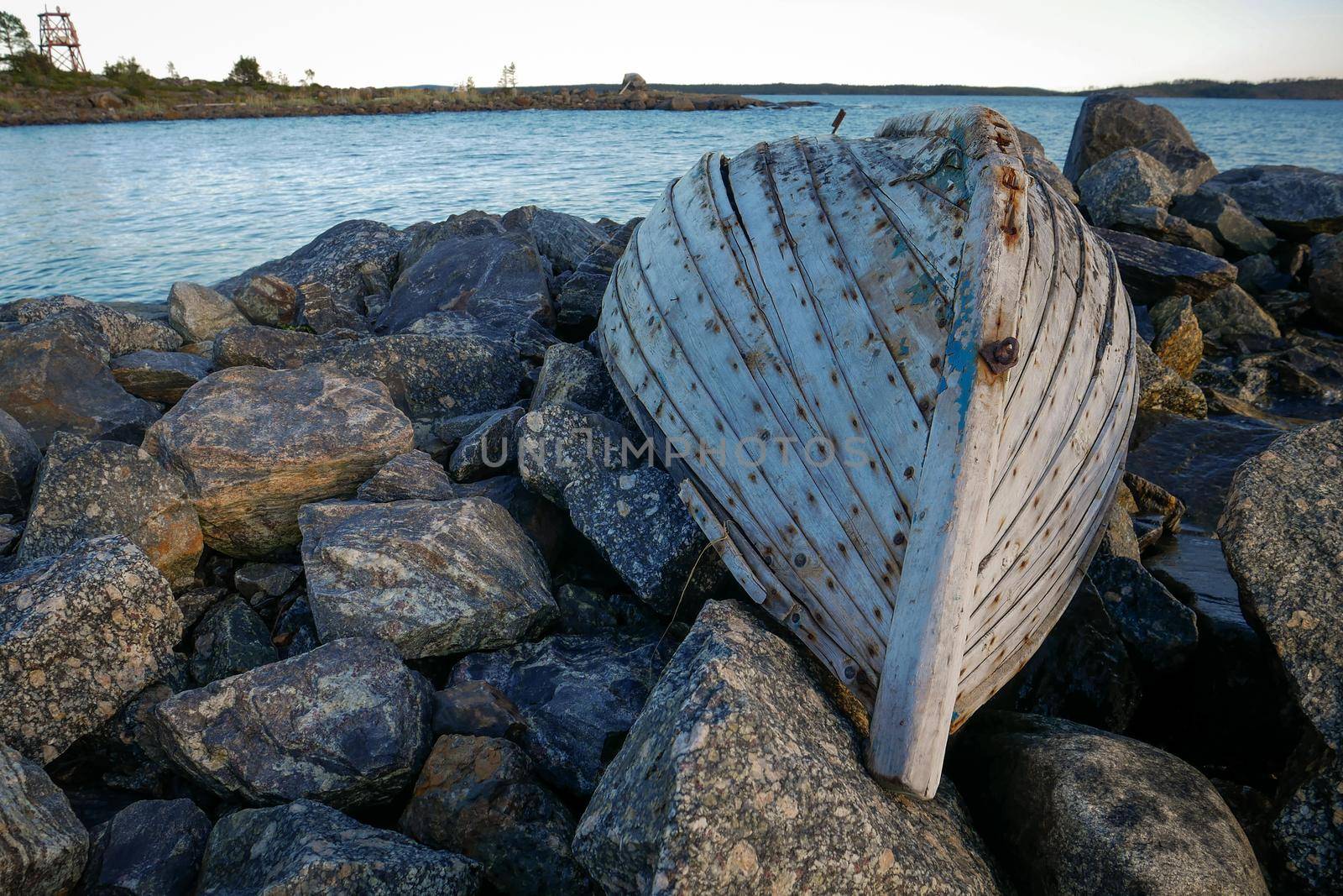 Old fishing boat on rock bay. White sea, Russia