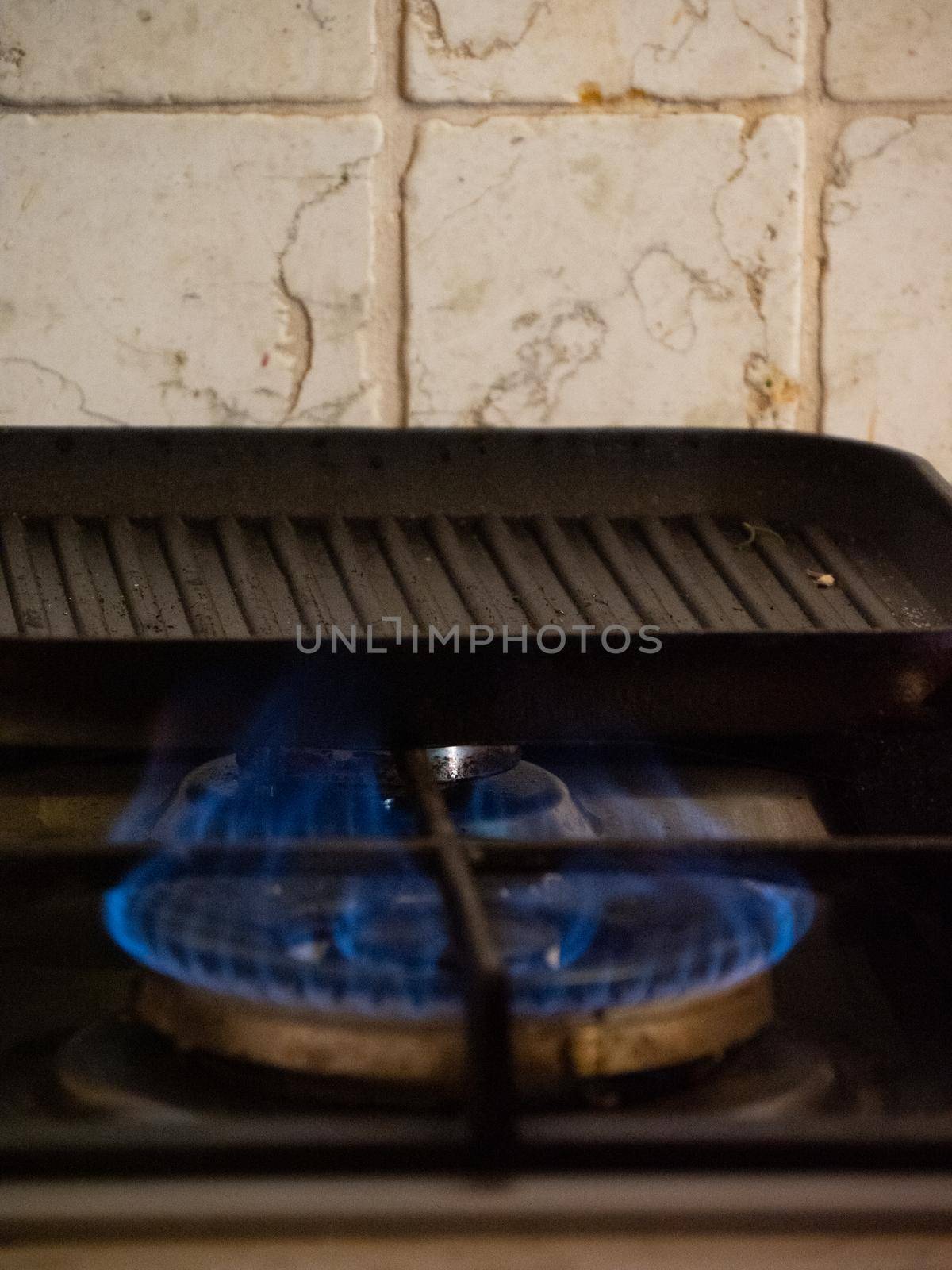 heating a grill above the fire in the kitchen by verbano