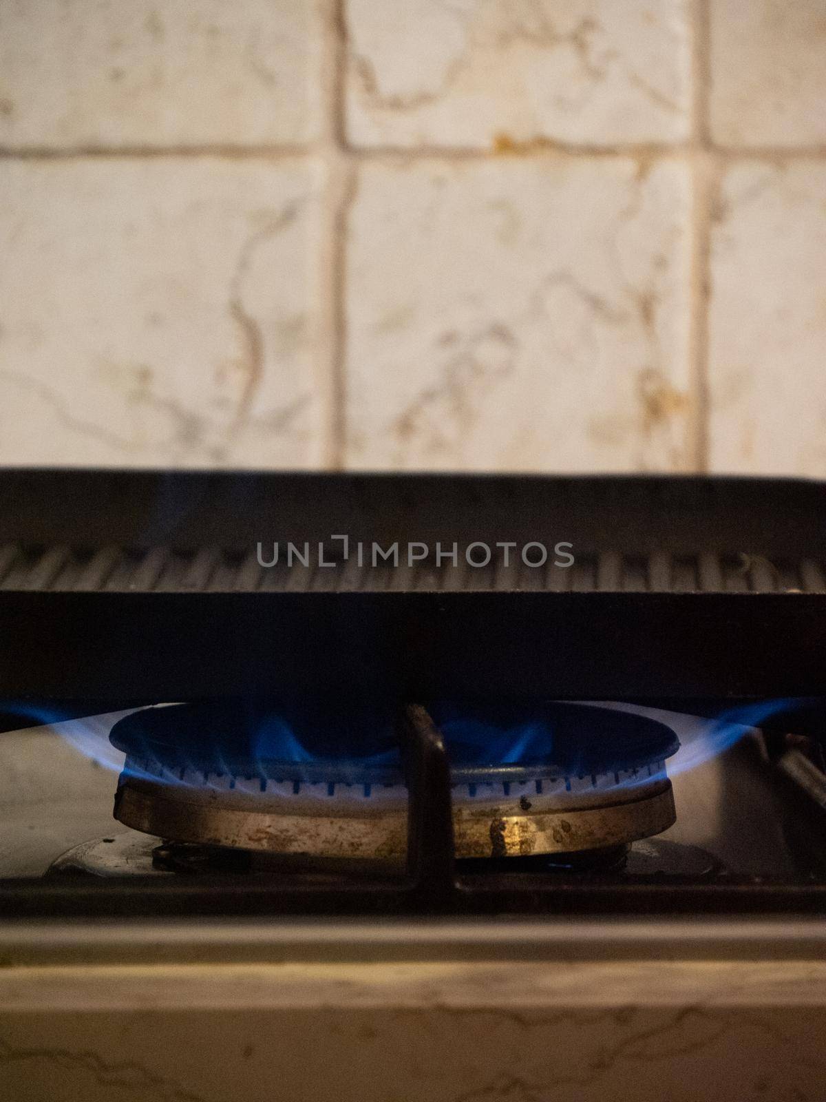 heating a grill above the fire in the kitchen by verbano
