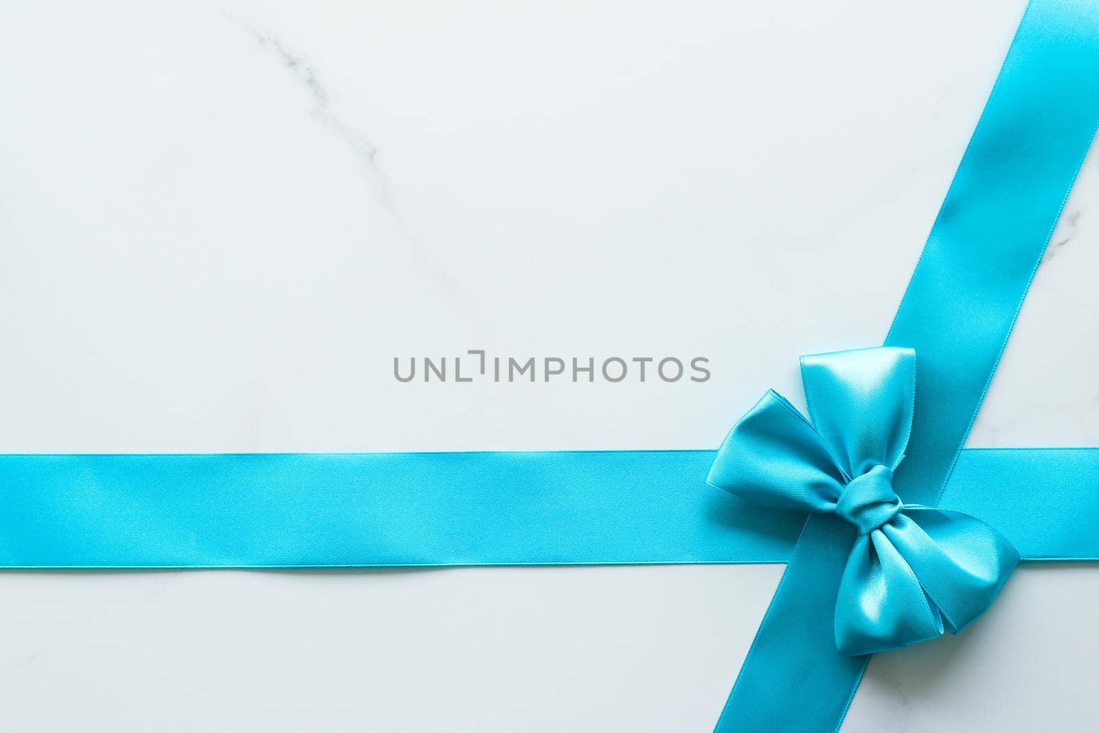 Holiday decor, feminine design and flatlay concept - Blue silk ribbon on marble, top view