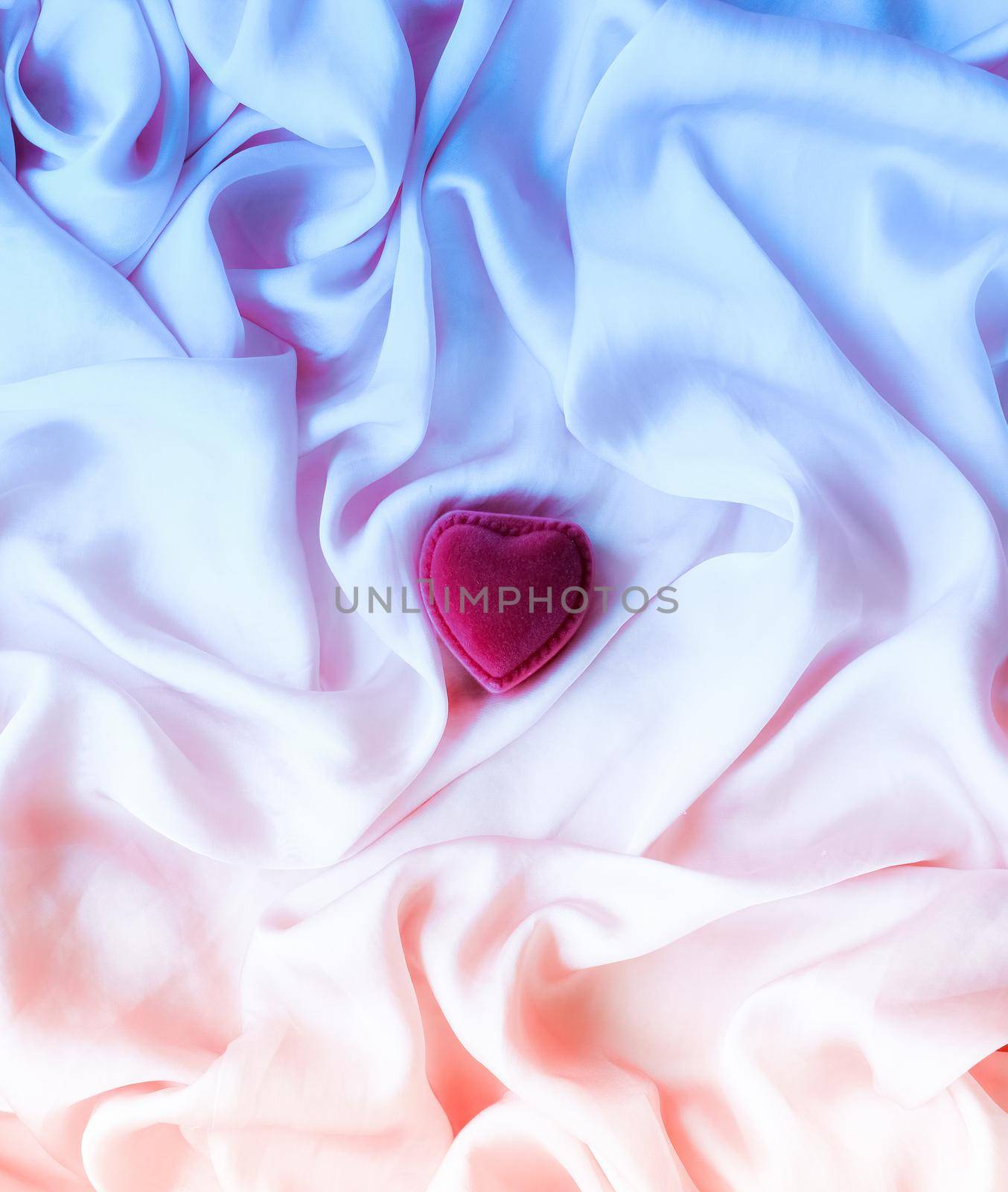 Valentine's day, true love, engagement and proposal concept - Heart-shaped gift box on neon silk. Will you be my Valentine?