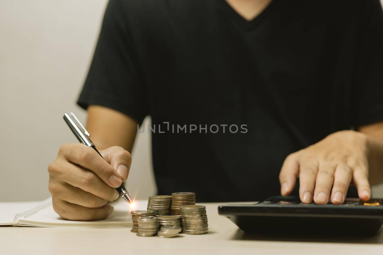 Businessman put coin stack money and many bank note in office.Business investment accounting finance Save money for future and Retirement.