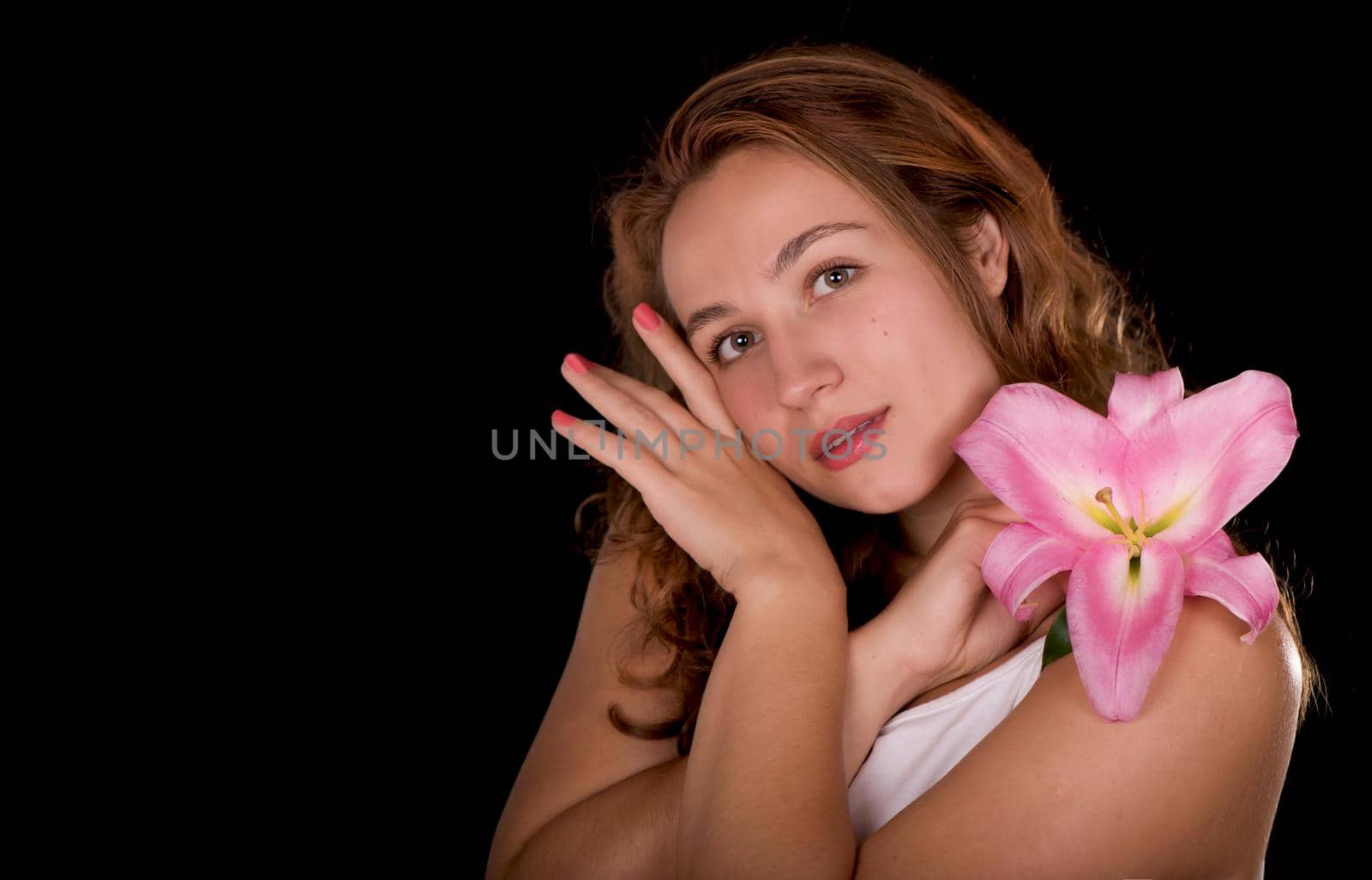 Beauty face of the young beautiful woman with flower on a white background