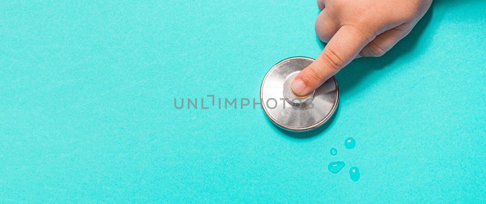 Stethoscope on pastel blue background from above by Ciorba